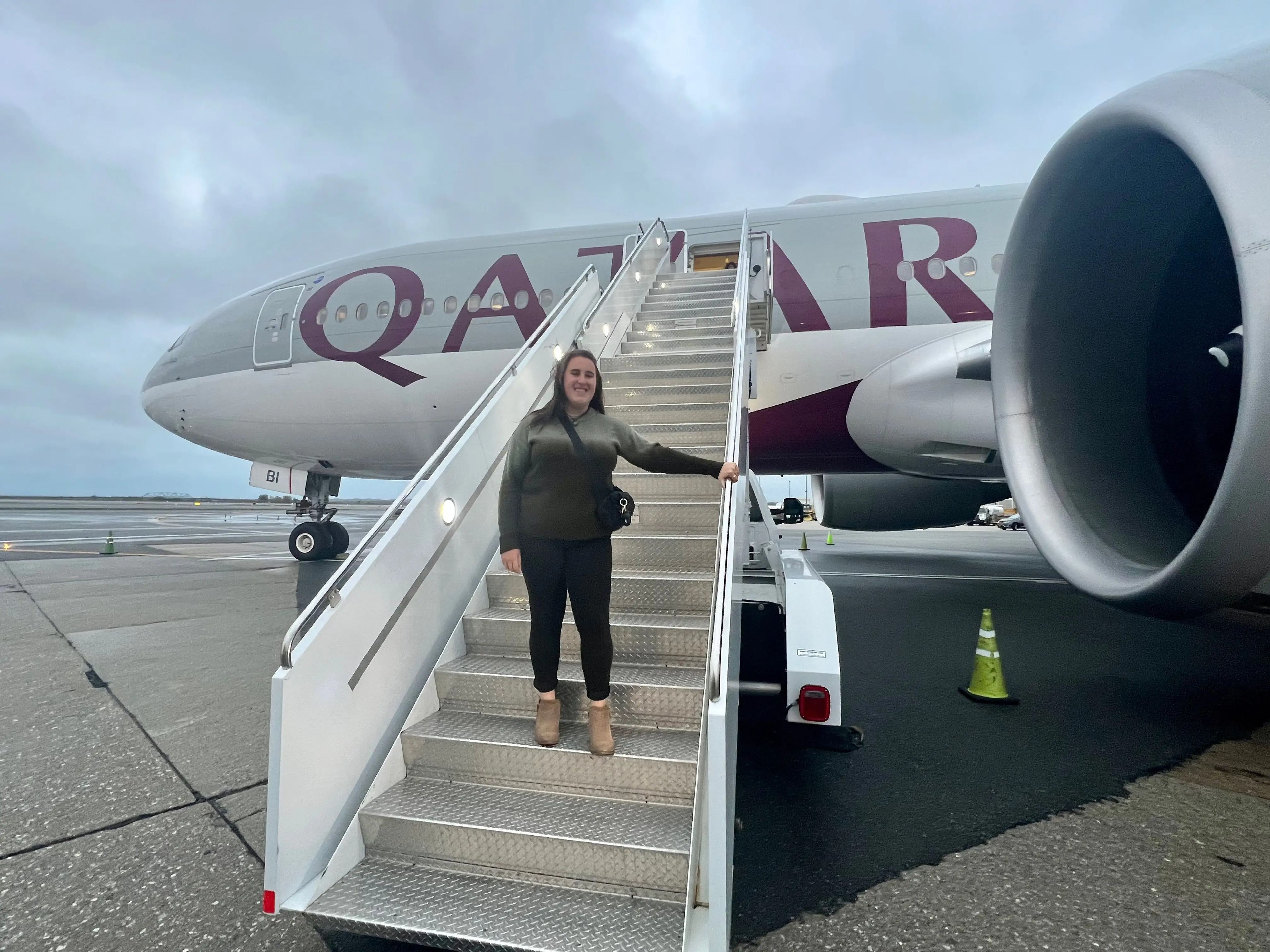 Standing on the airstairs leading to Qatar's Boeing 777-200LR.