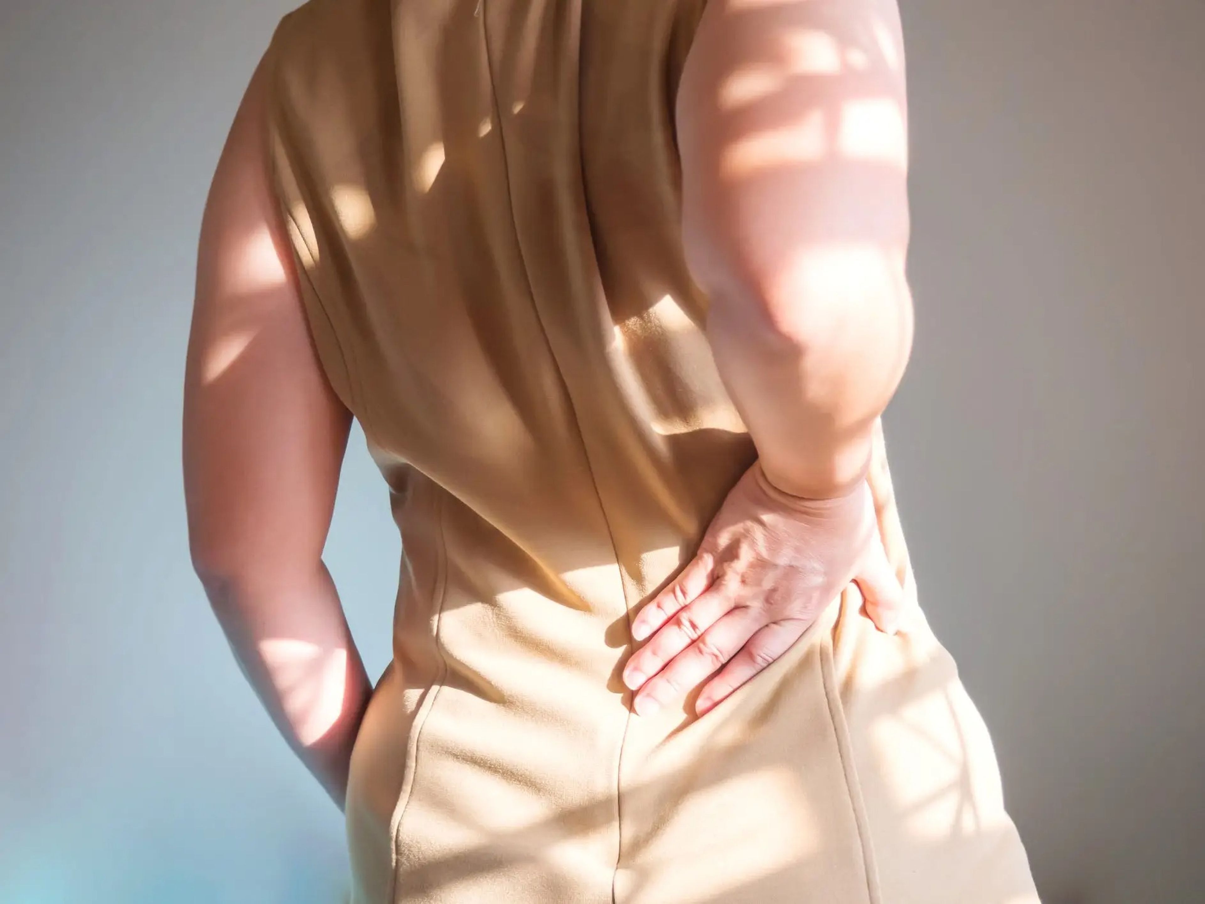 Woman having lower back pain.