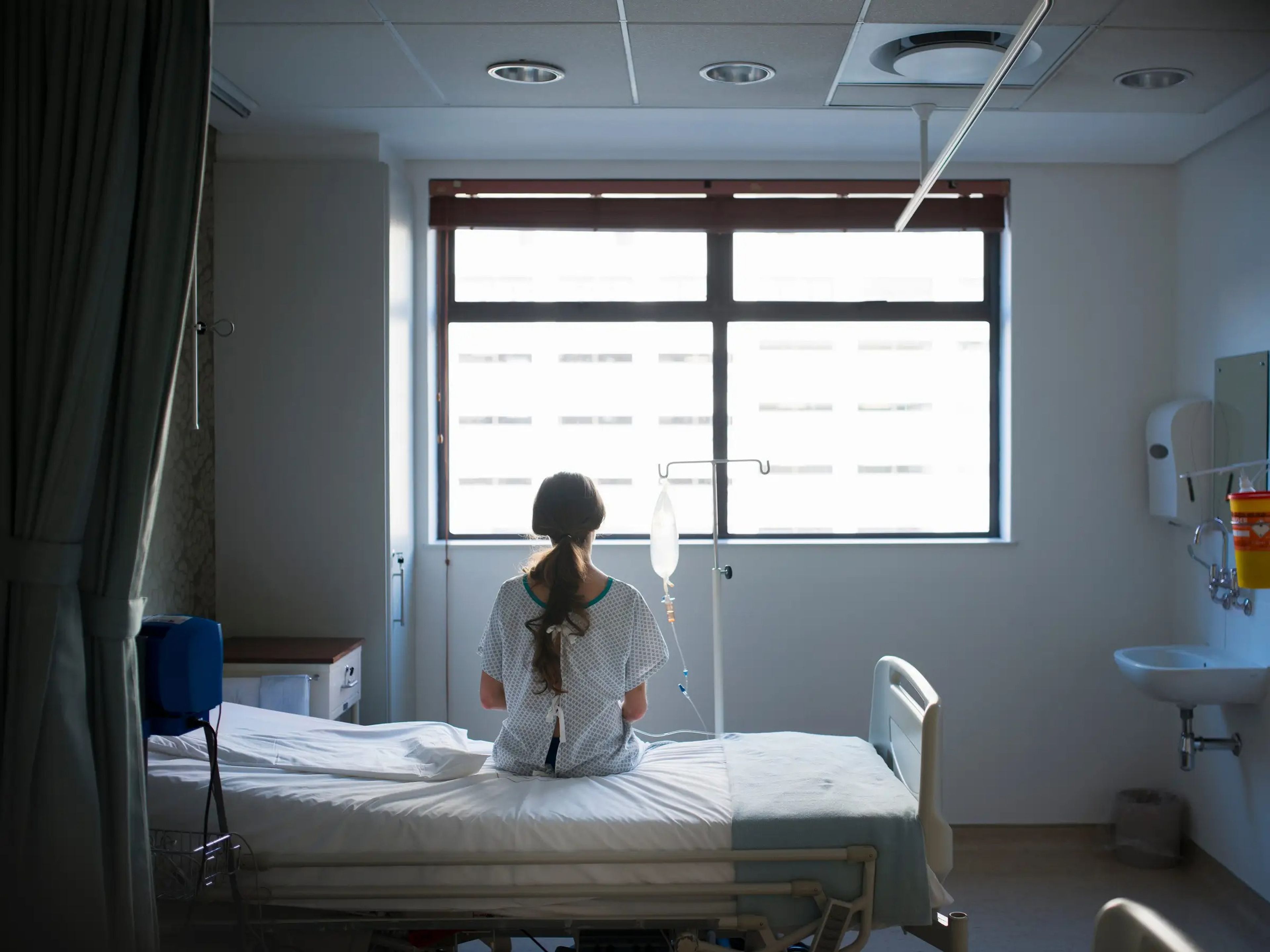 A woman sitting on a hospital bed