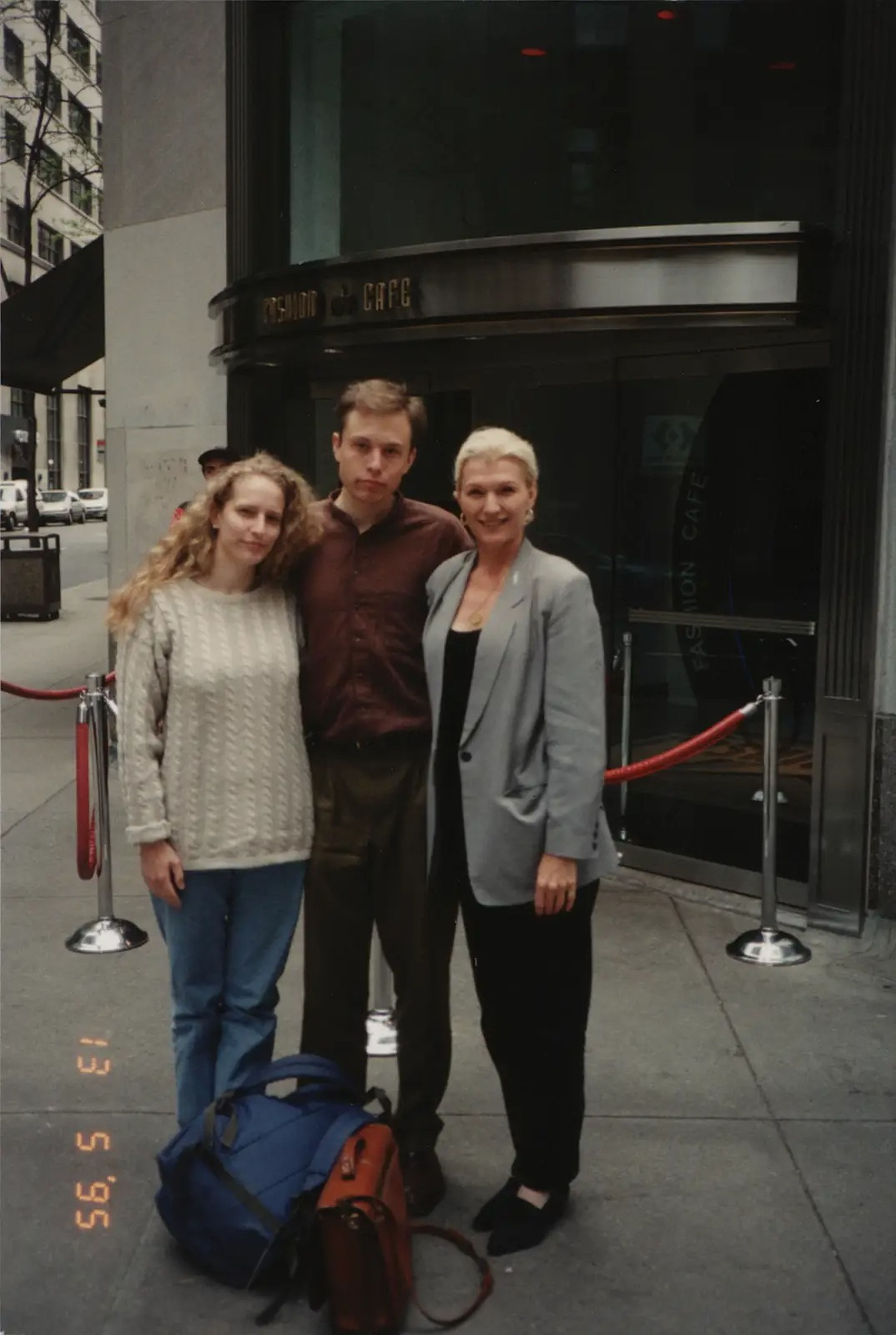Elon Musk standing between his mother Maye Musk and his then-girlfriend Jennifer Gwynne.