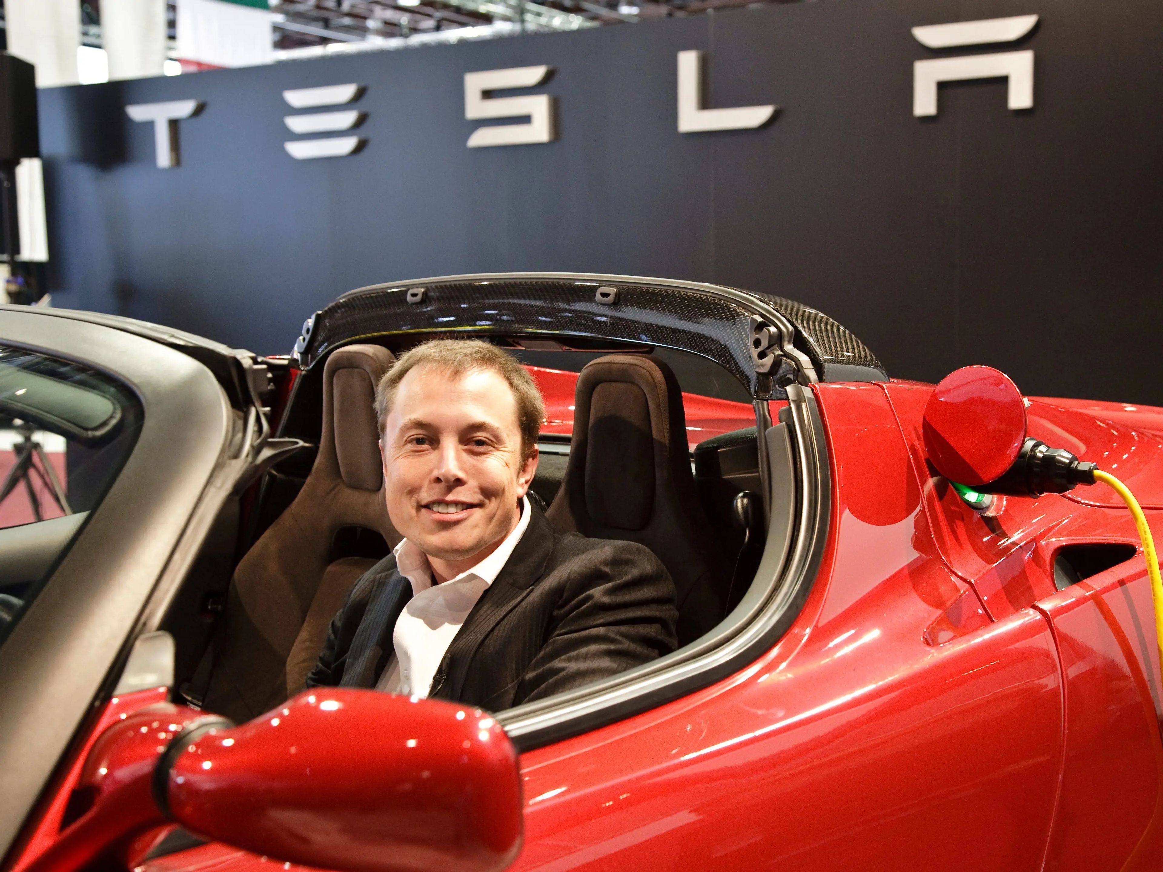 Elon Musk in a Tesla Roadster.