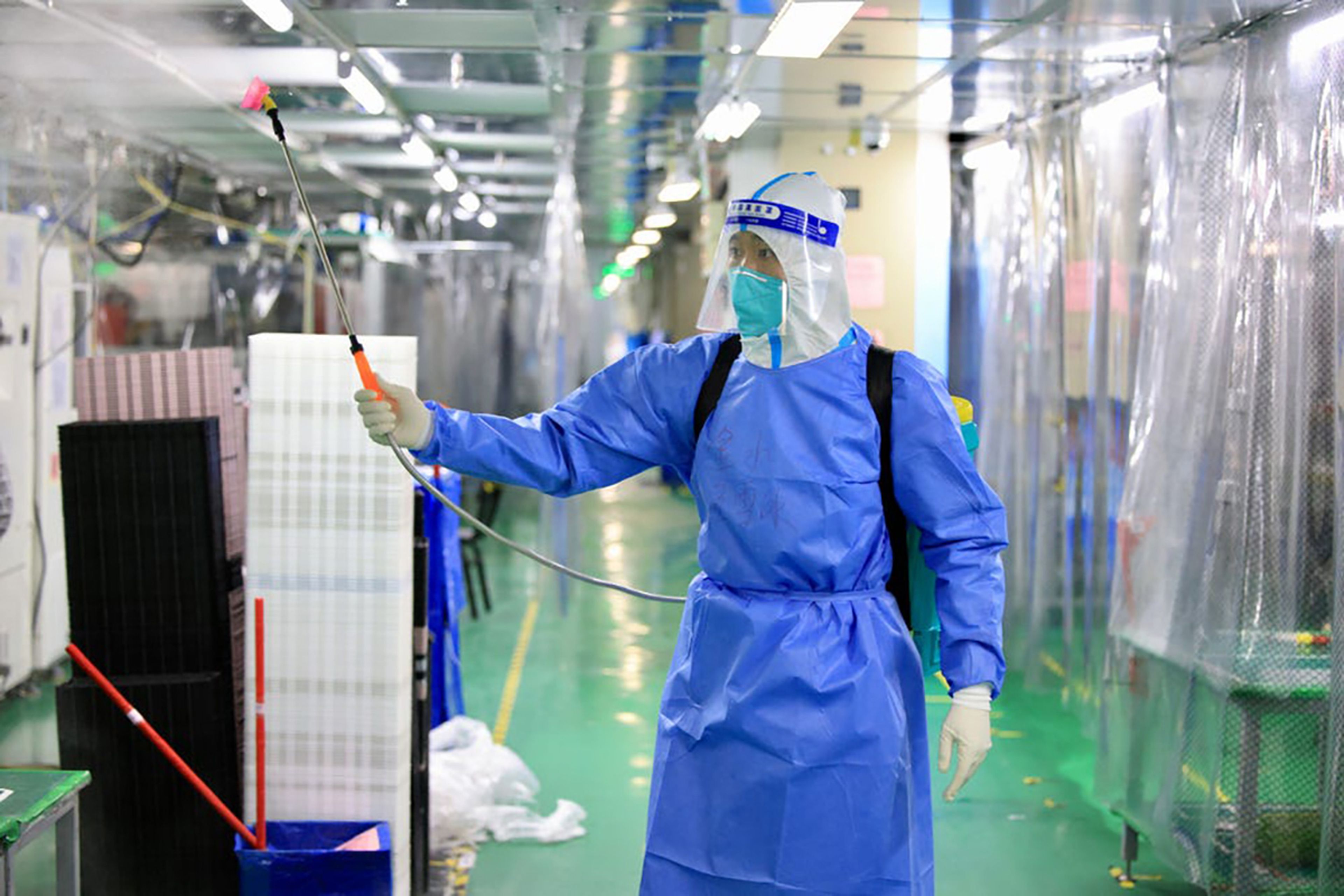 Un empleado con equipo de protección desinfecta una fábrica de Foxconn en Zhengzhou, provincia china de Henan.