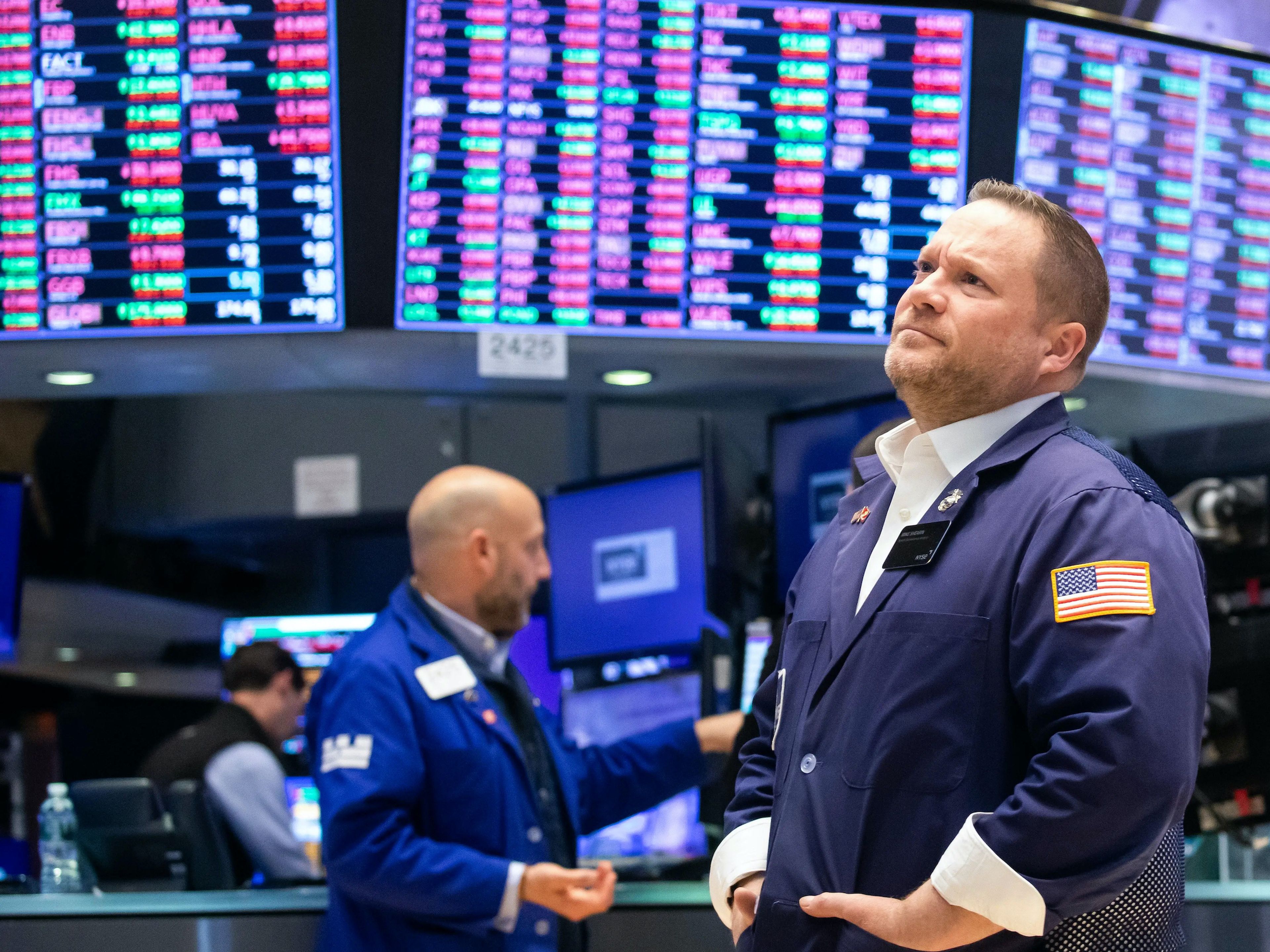 Una gran pantalla con los precios de las acciones aparece detrás de los operadores que trabajan en la Bolsa de Nueva York, el 9 de mayo de 2022. 
