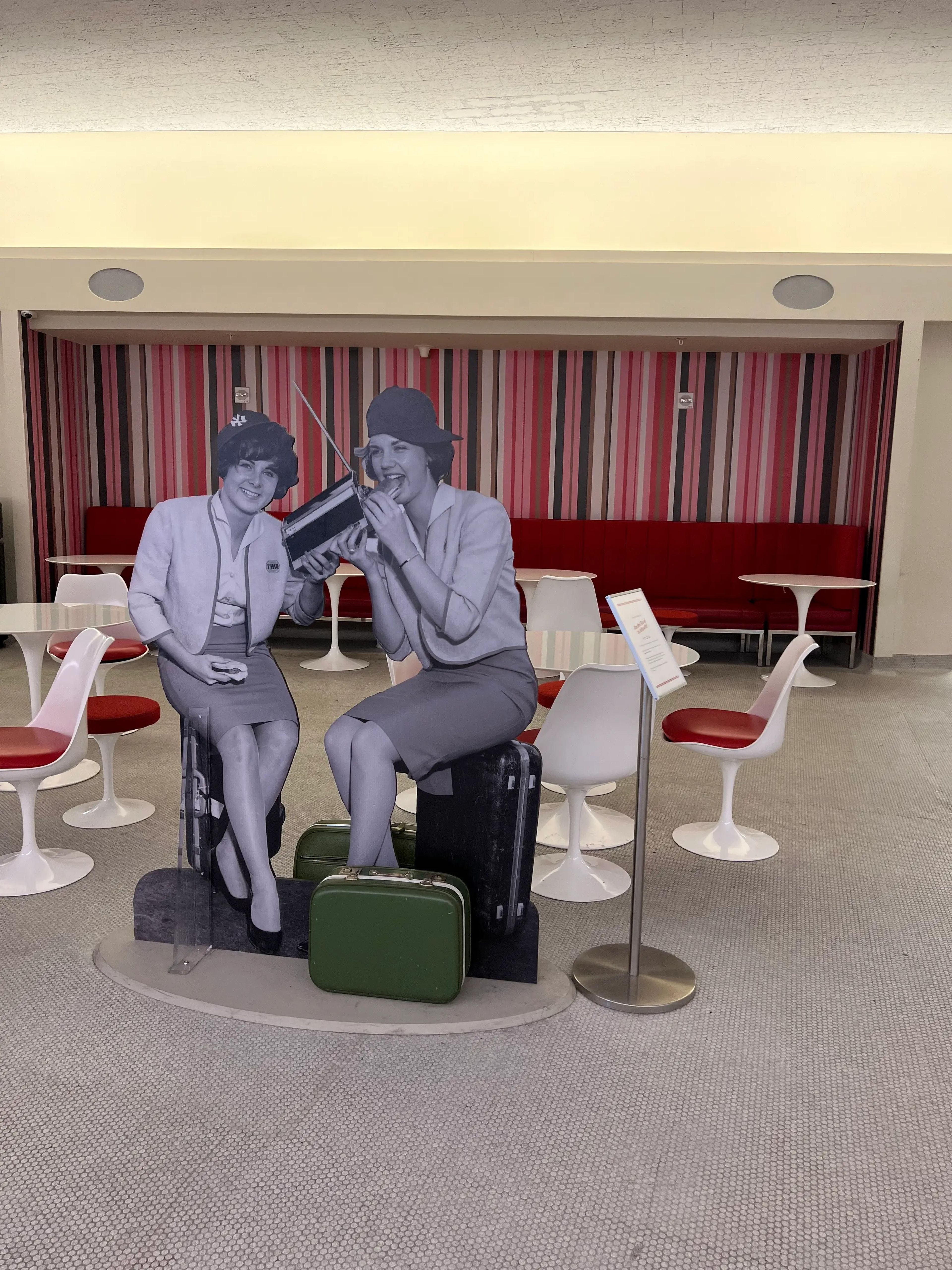 TWA Hotel posters of people in 60s clothes