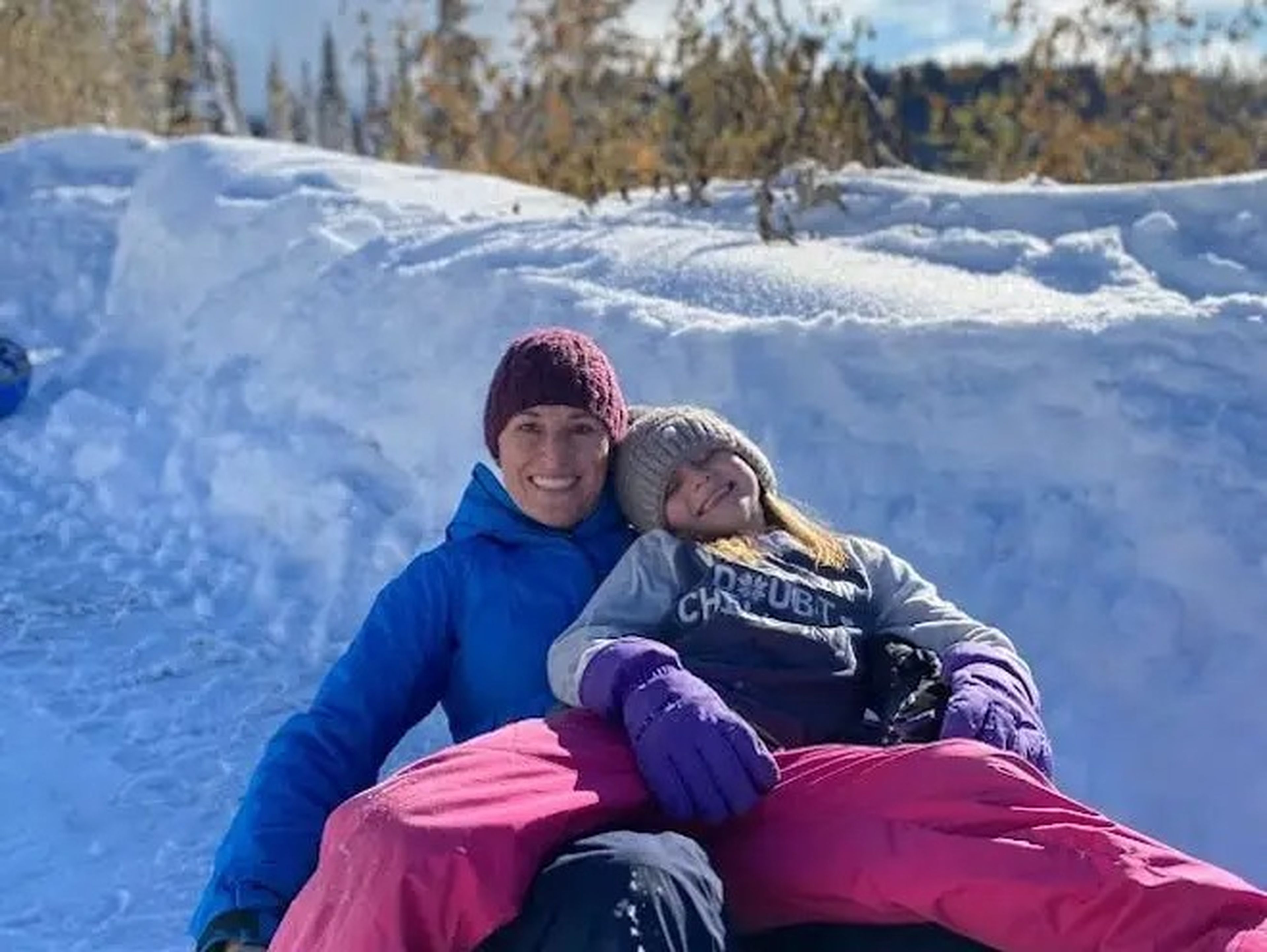 mom and daughter snow tubing