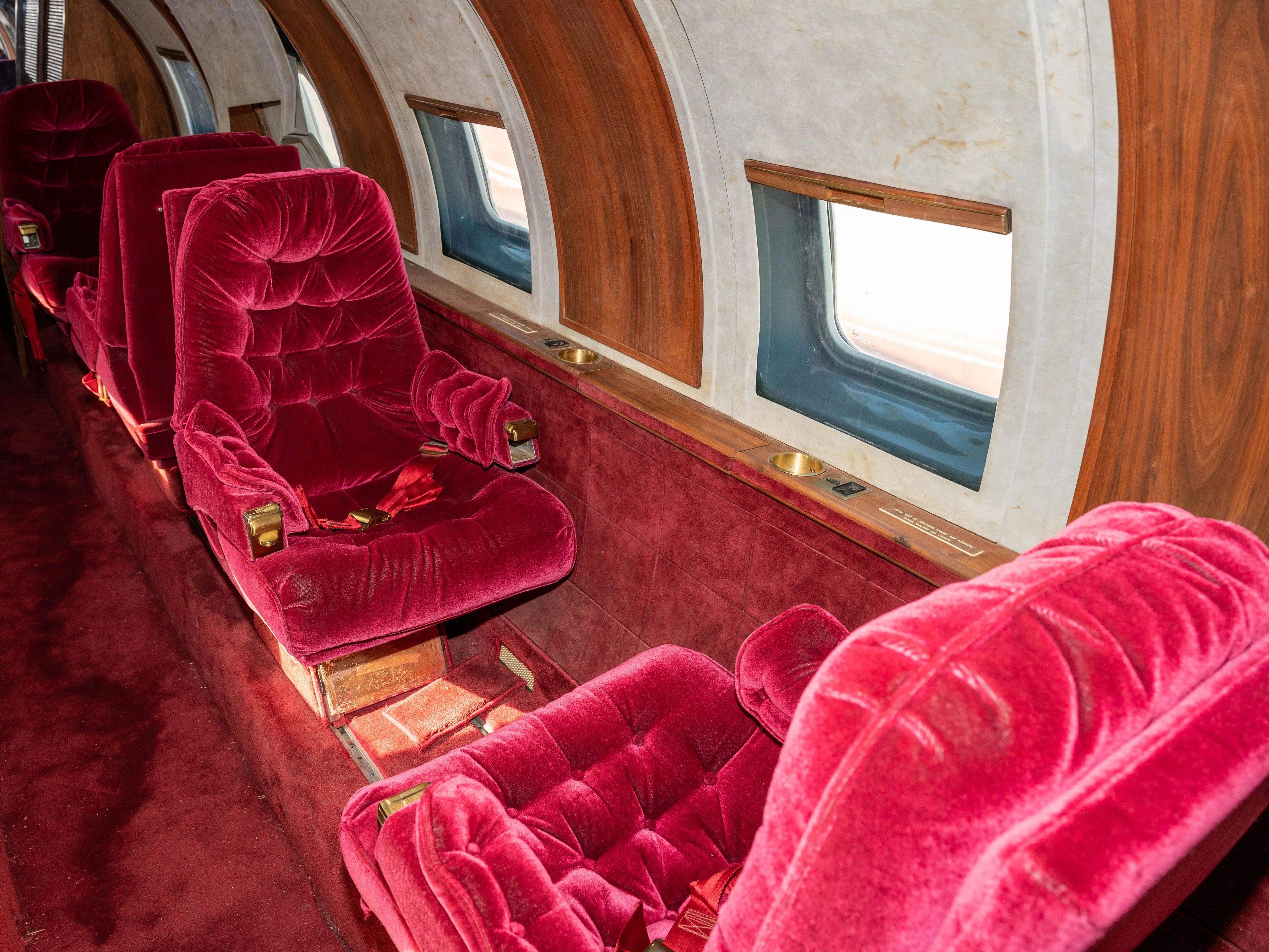 Photo of the red velvet seats inside which swivel and recline