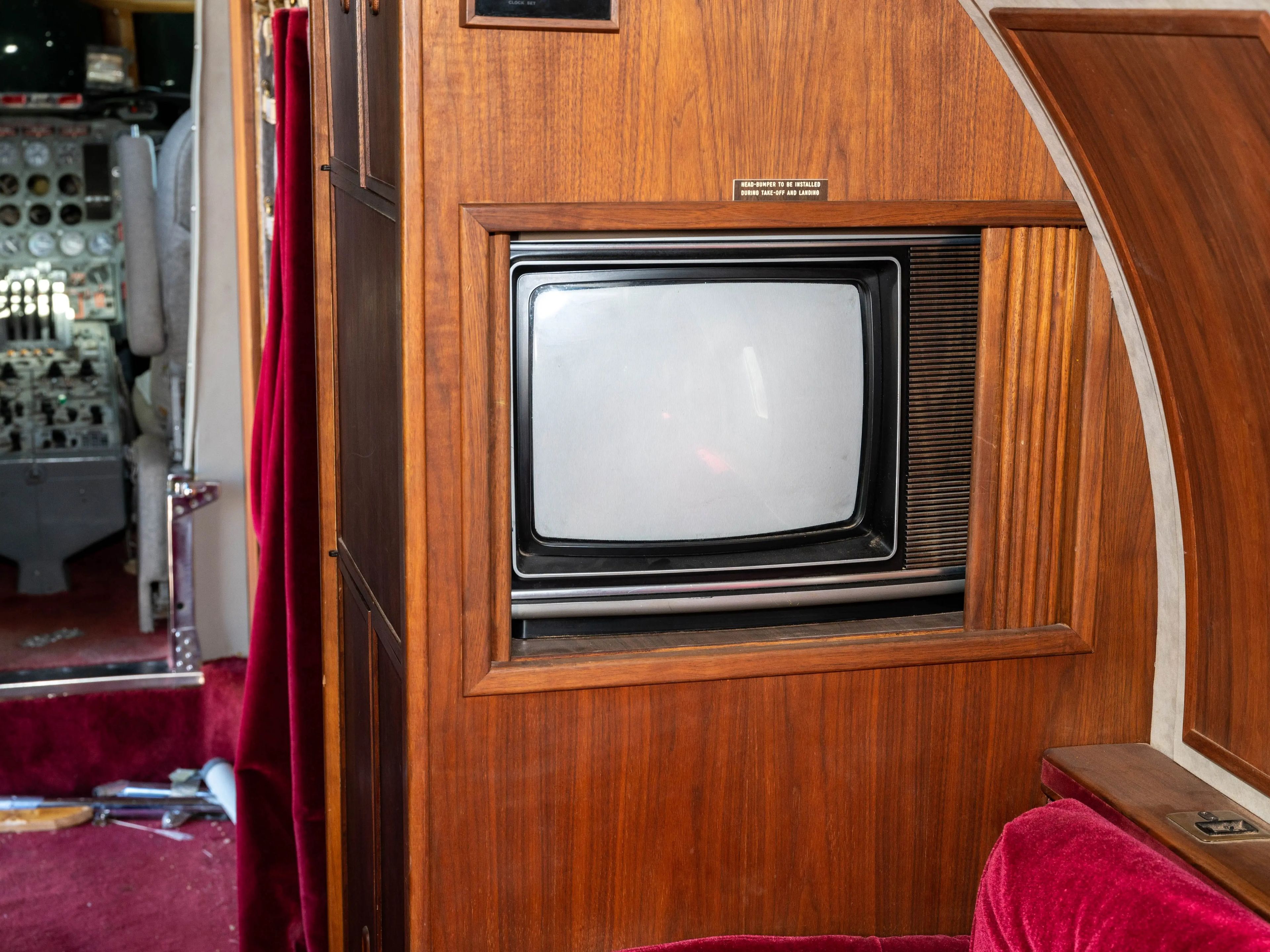 Photo of a TV inside a wooden cabinet on the private jet
