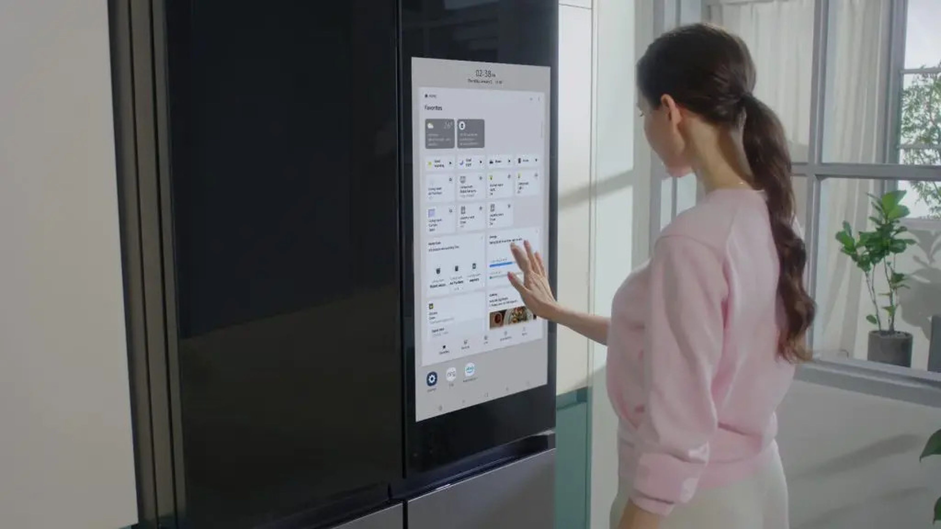 woman using samsung bespoke fridge plus