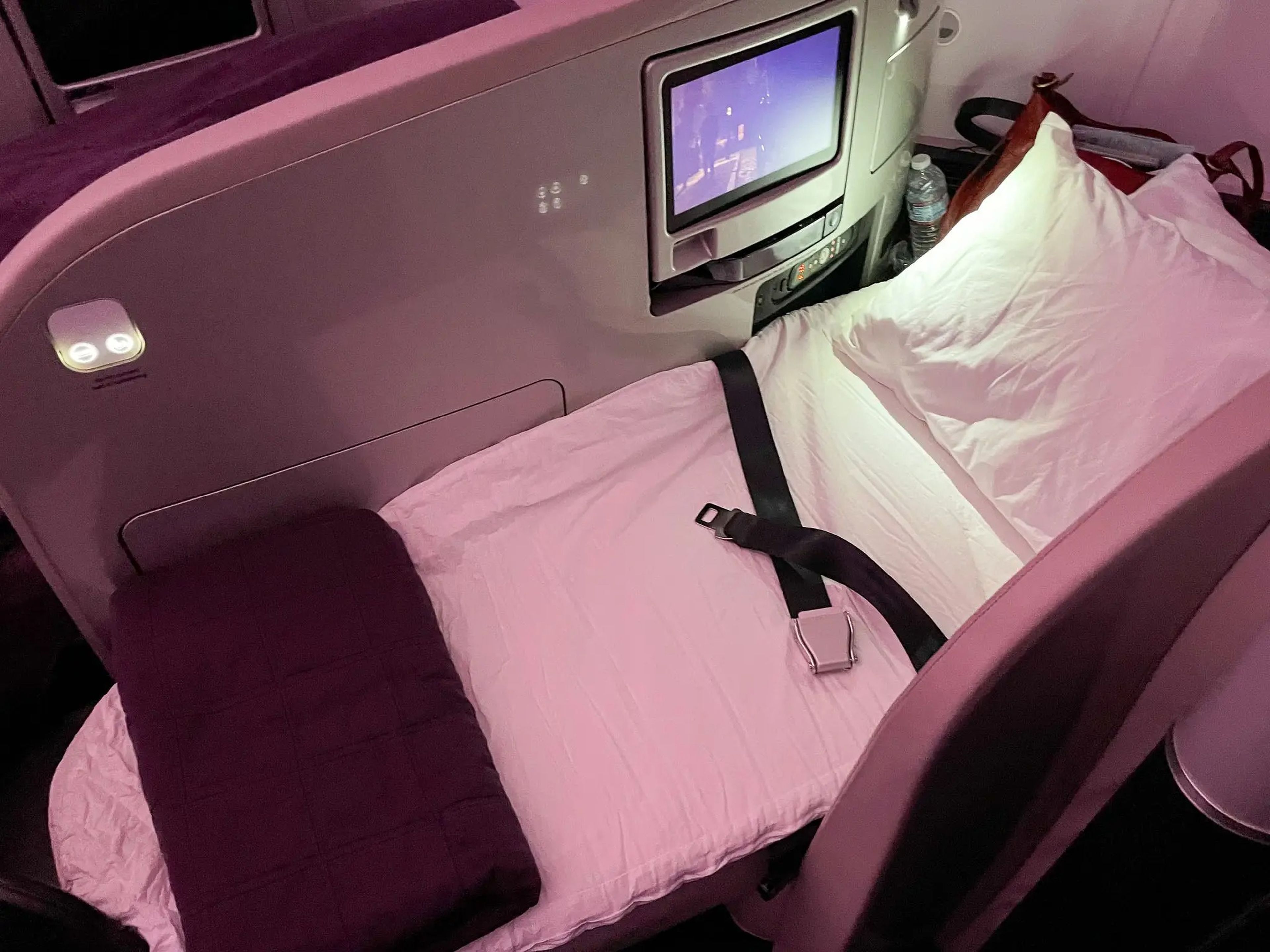 After dinner, flight attendants stopped at each seat to convert it into a bed.