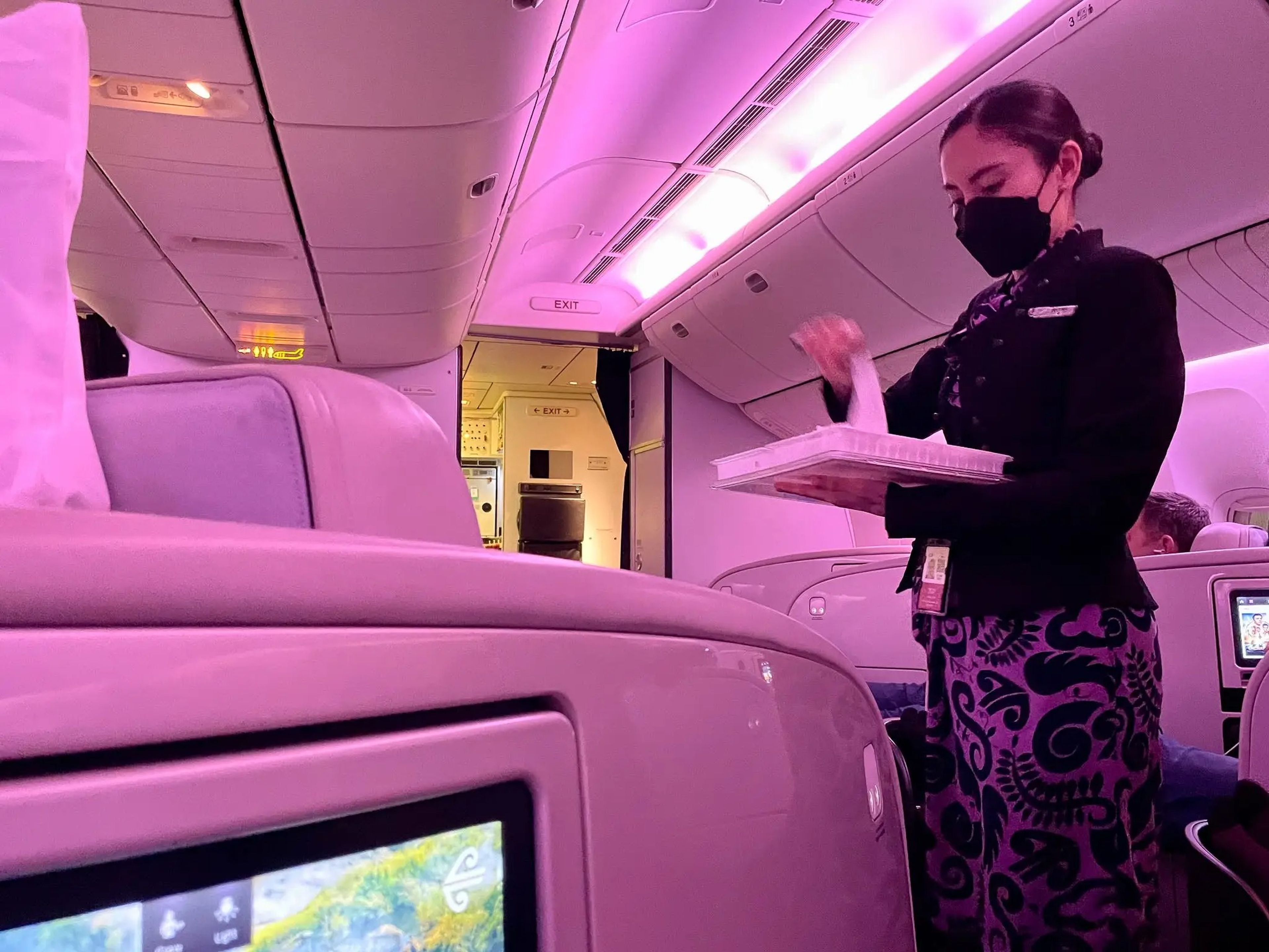 An Air New Zealand flight attendant passed out warm towels to business-class travelers.
