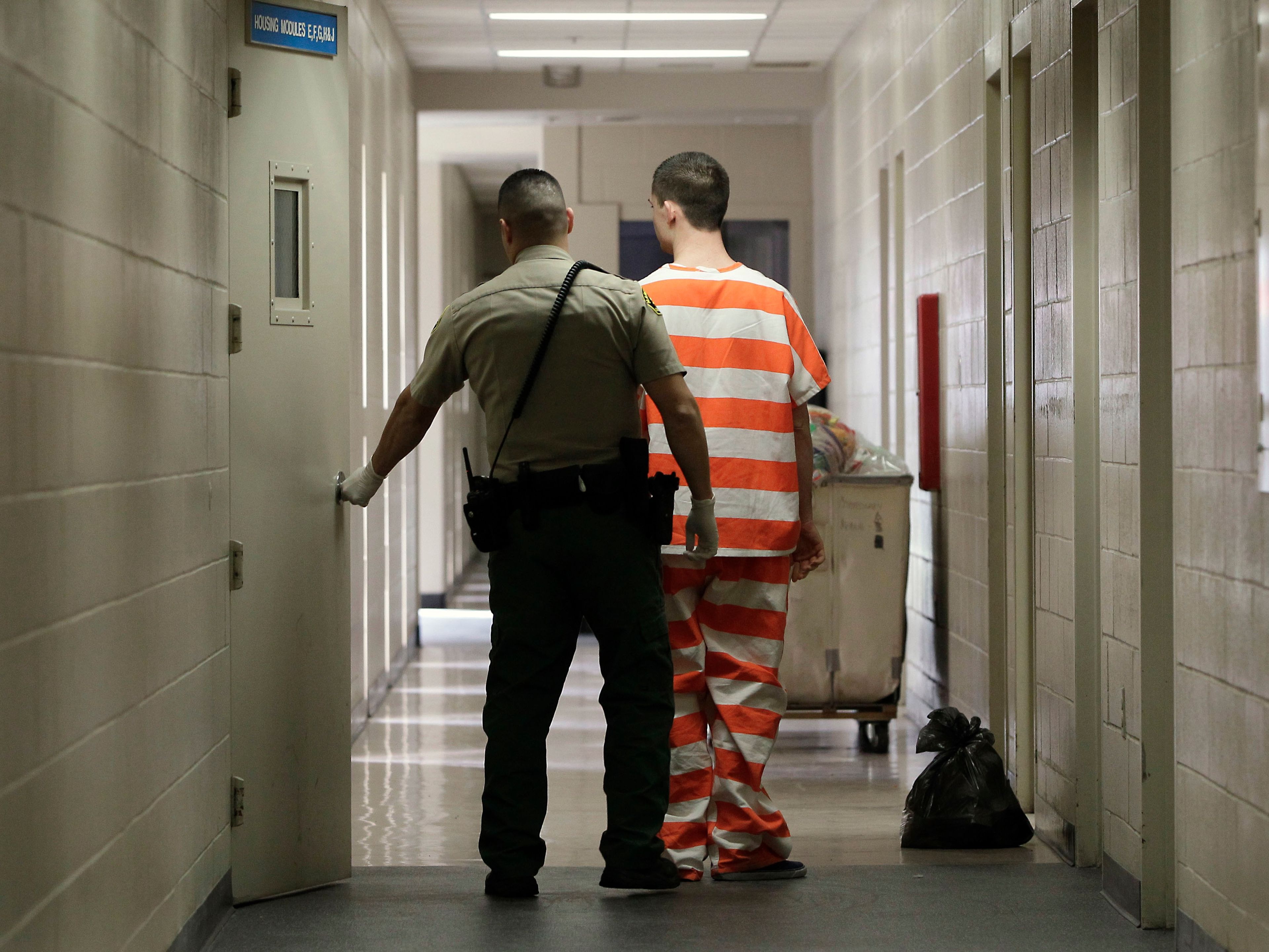 In This Thursday, Feb. 21, 2013 Photo, A Prison Inmate Is Brought Into An Inmate Housing Unit In Madera, Calif. 