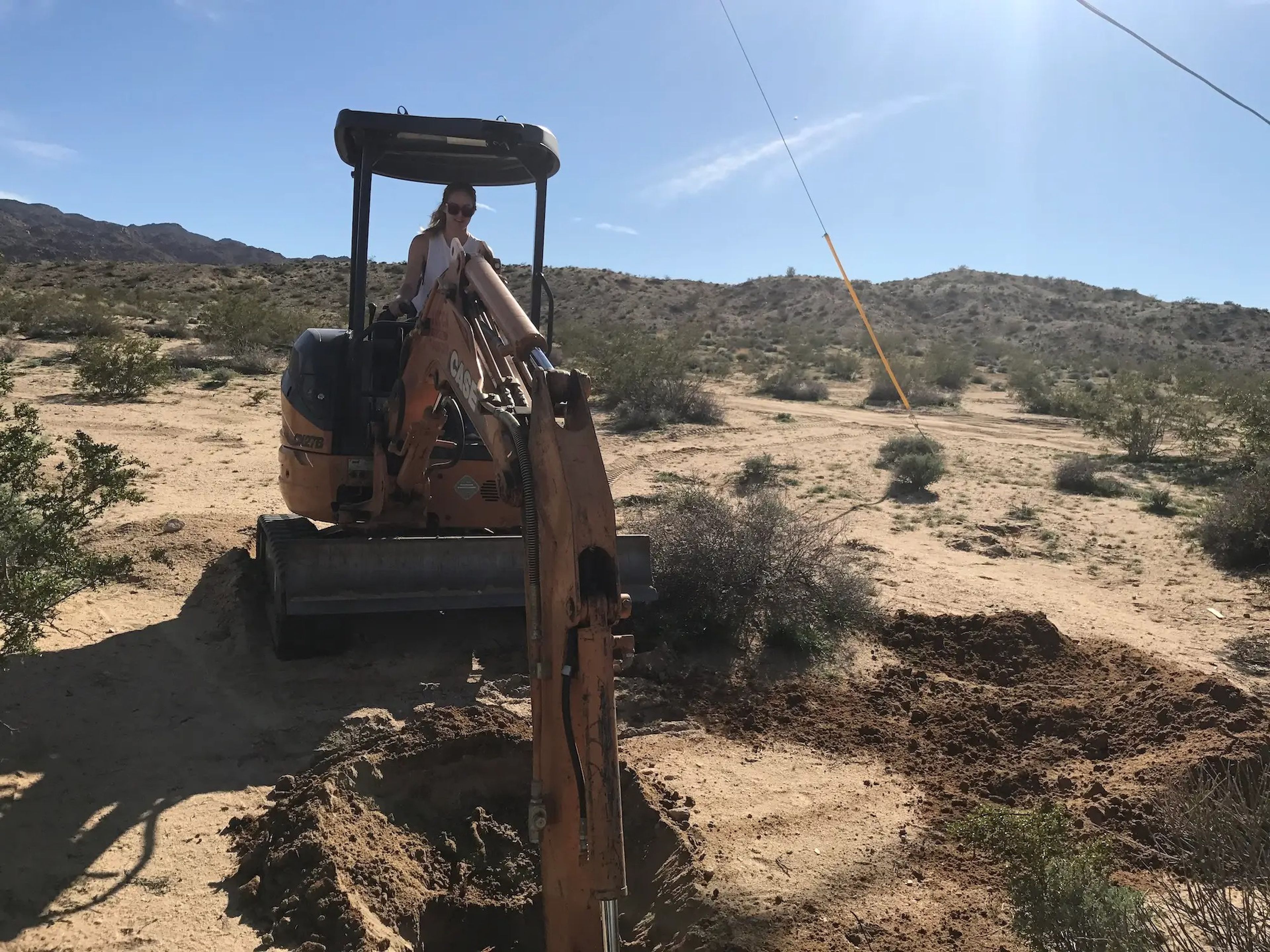 Hillary Flur operating a small bulldozer