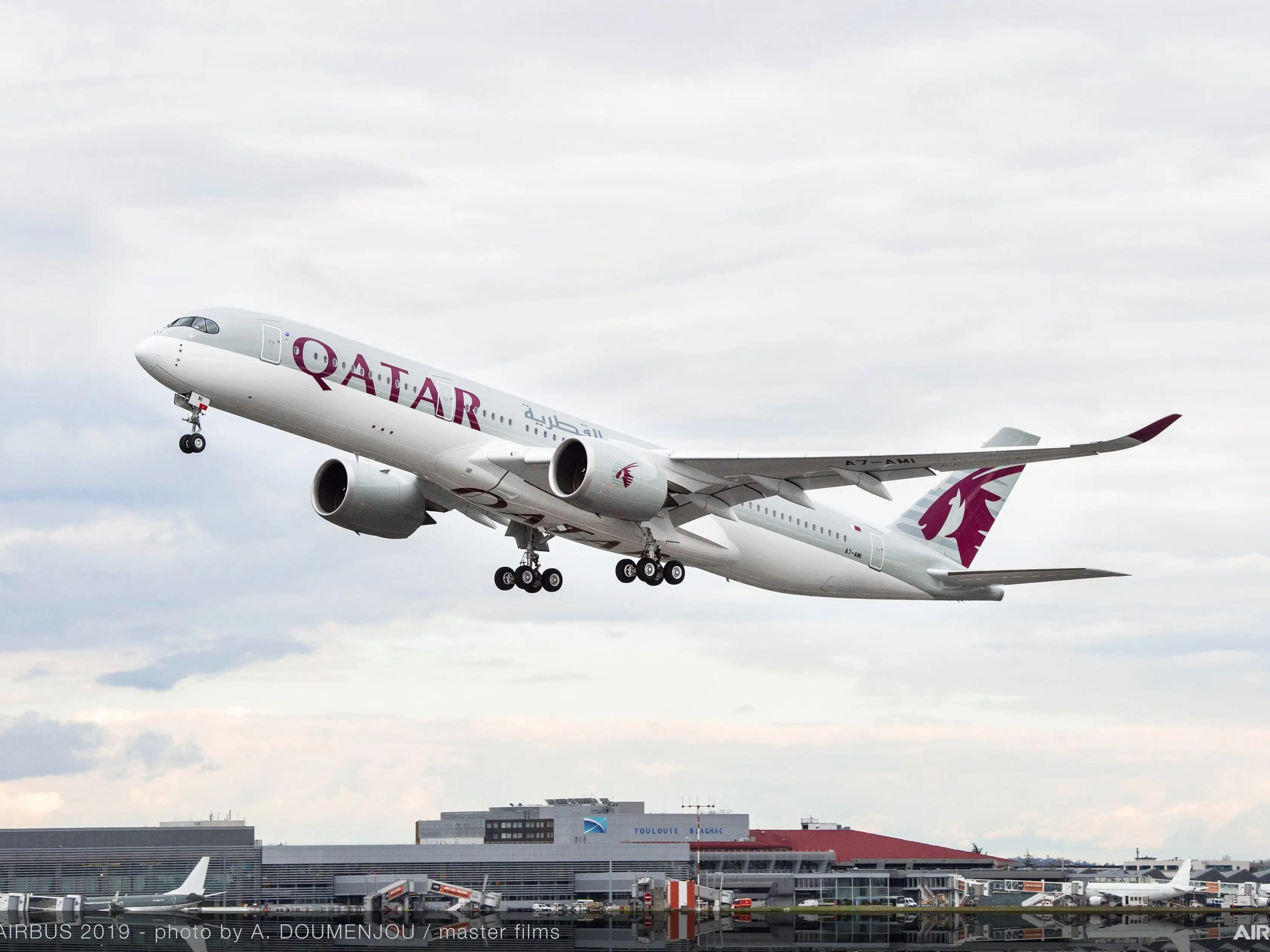 A Qatar Airways A350-900 aircraft taking off.