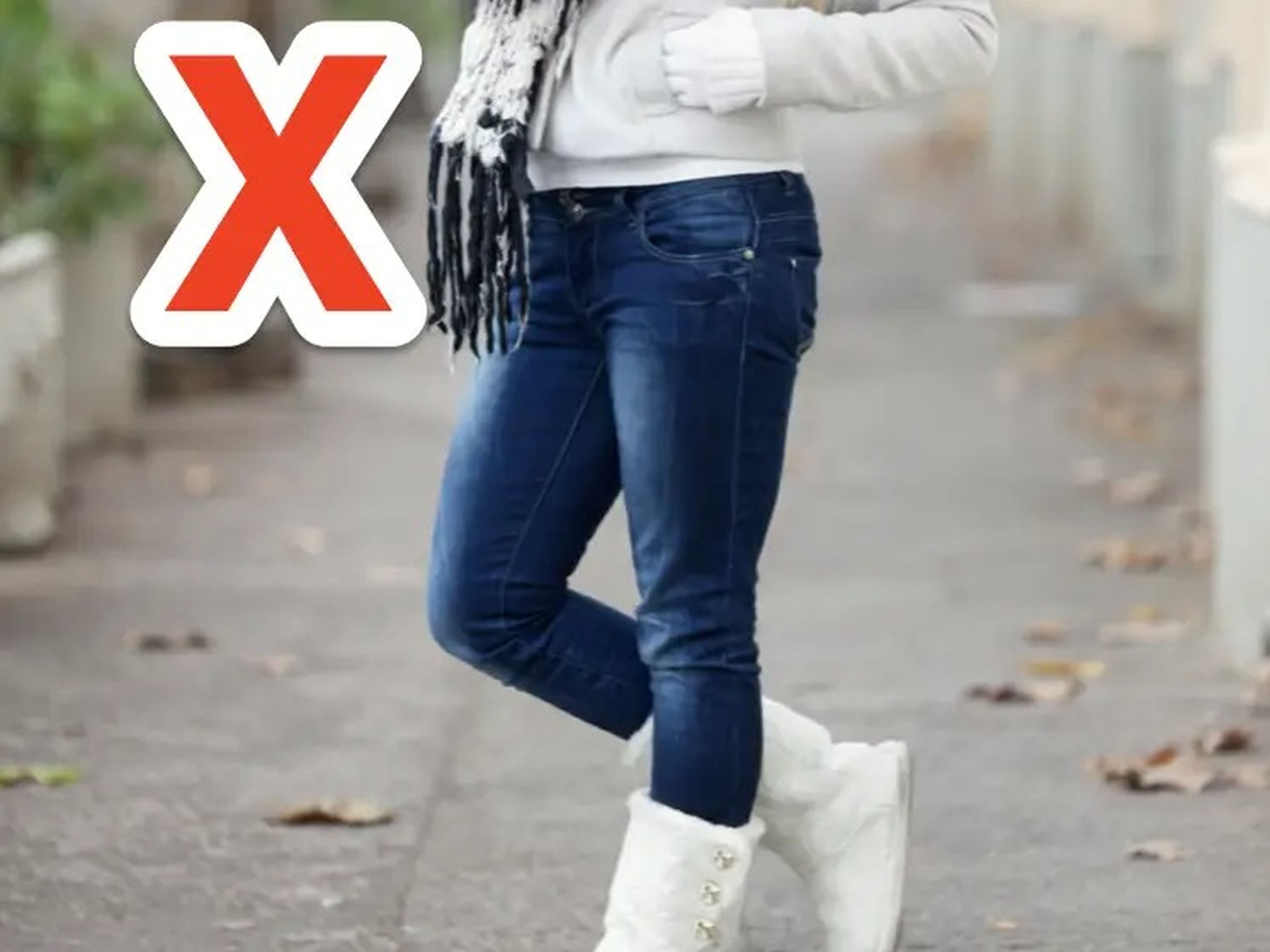 red x over woman wearing low-rise skinny jeans, a cream jacket, and white furry boots