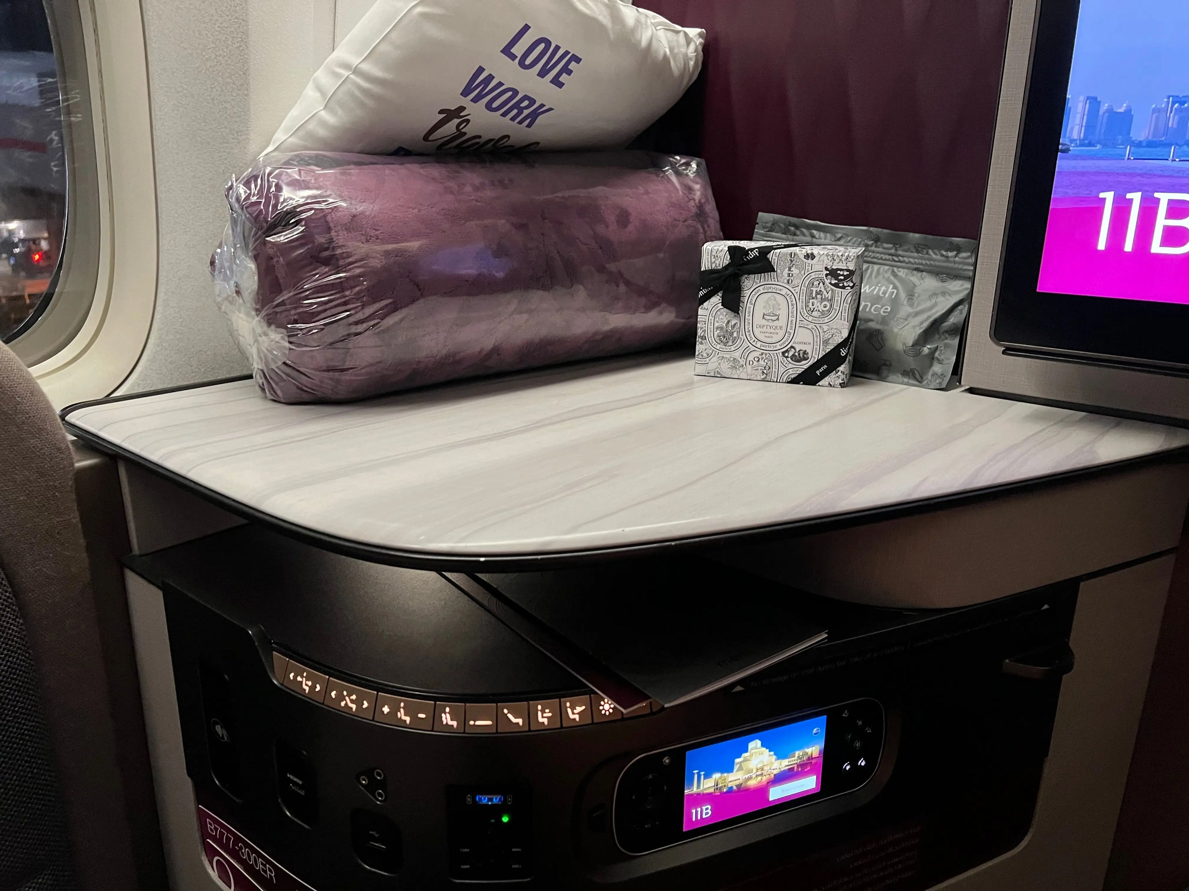 The seat had an amenity kit, noise-canceling headphones, a plush blanket, and two pillows.