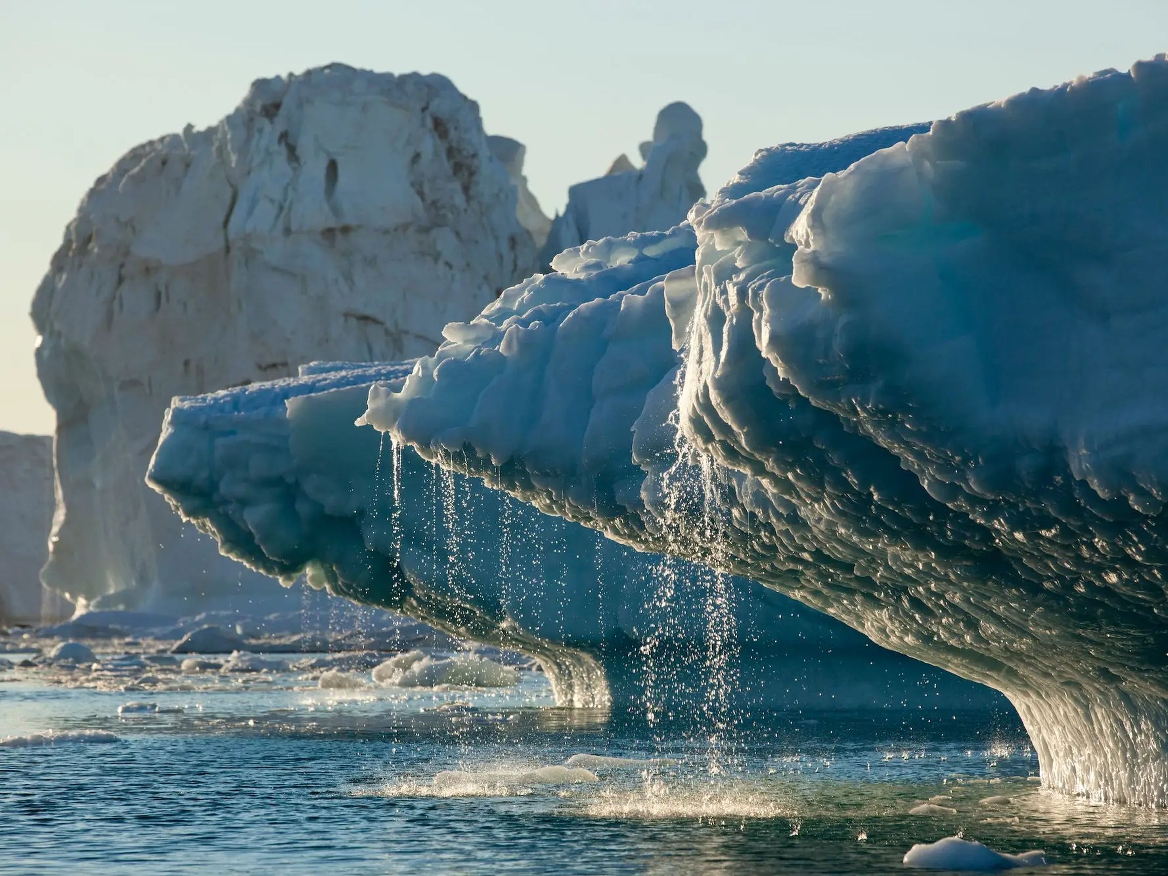 Water is seen streaming off of icebergs in in Disko Bay, Greenland, that were recently calved from the Ilulissat (Jakobshavn) Glacier