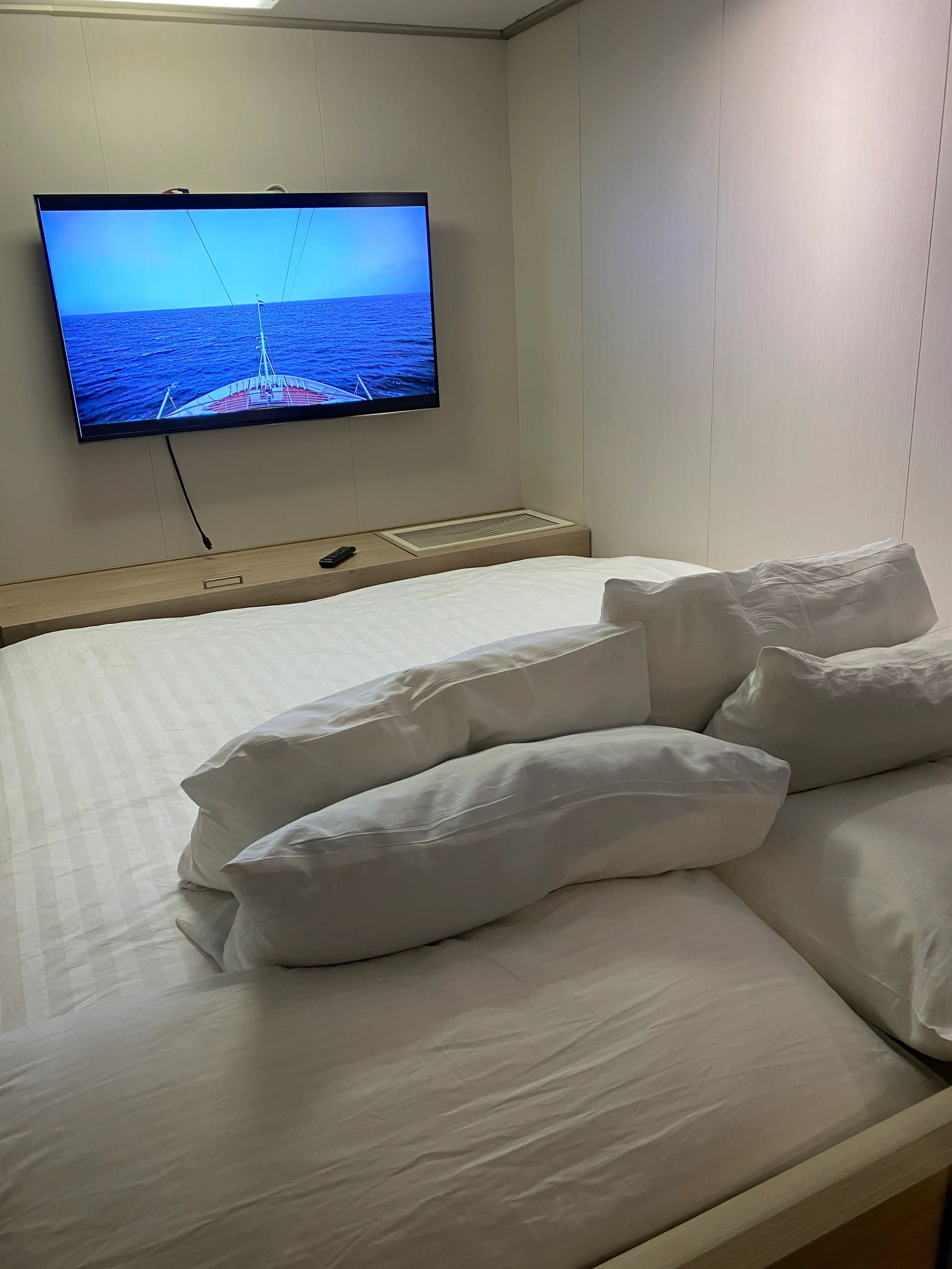 bed facing tv on wall
