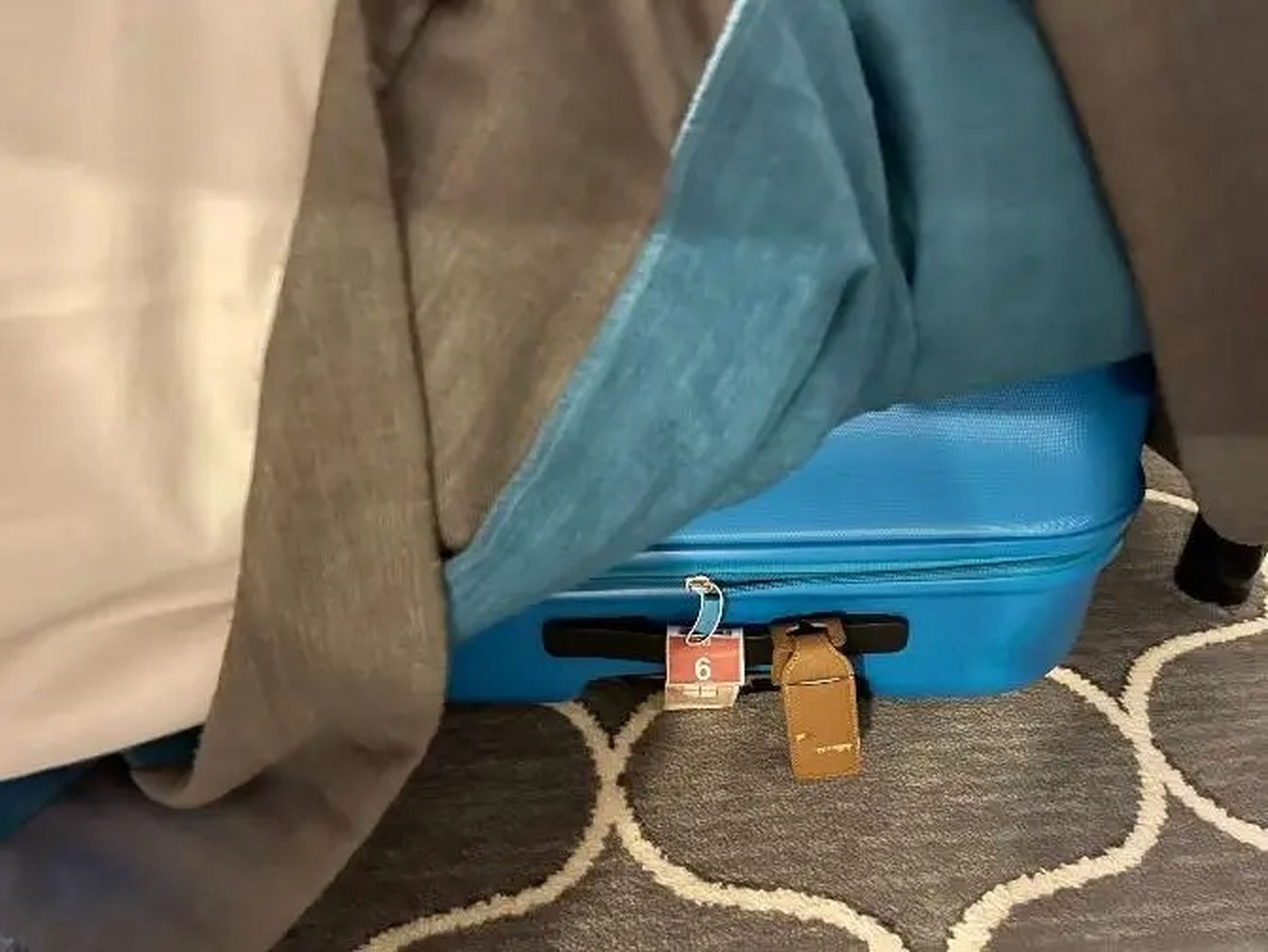 blue suitcase underneath the bed in interior cabin symphony of the seas