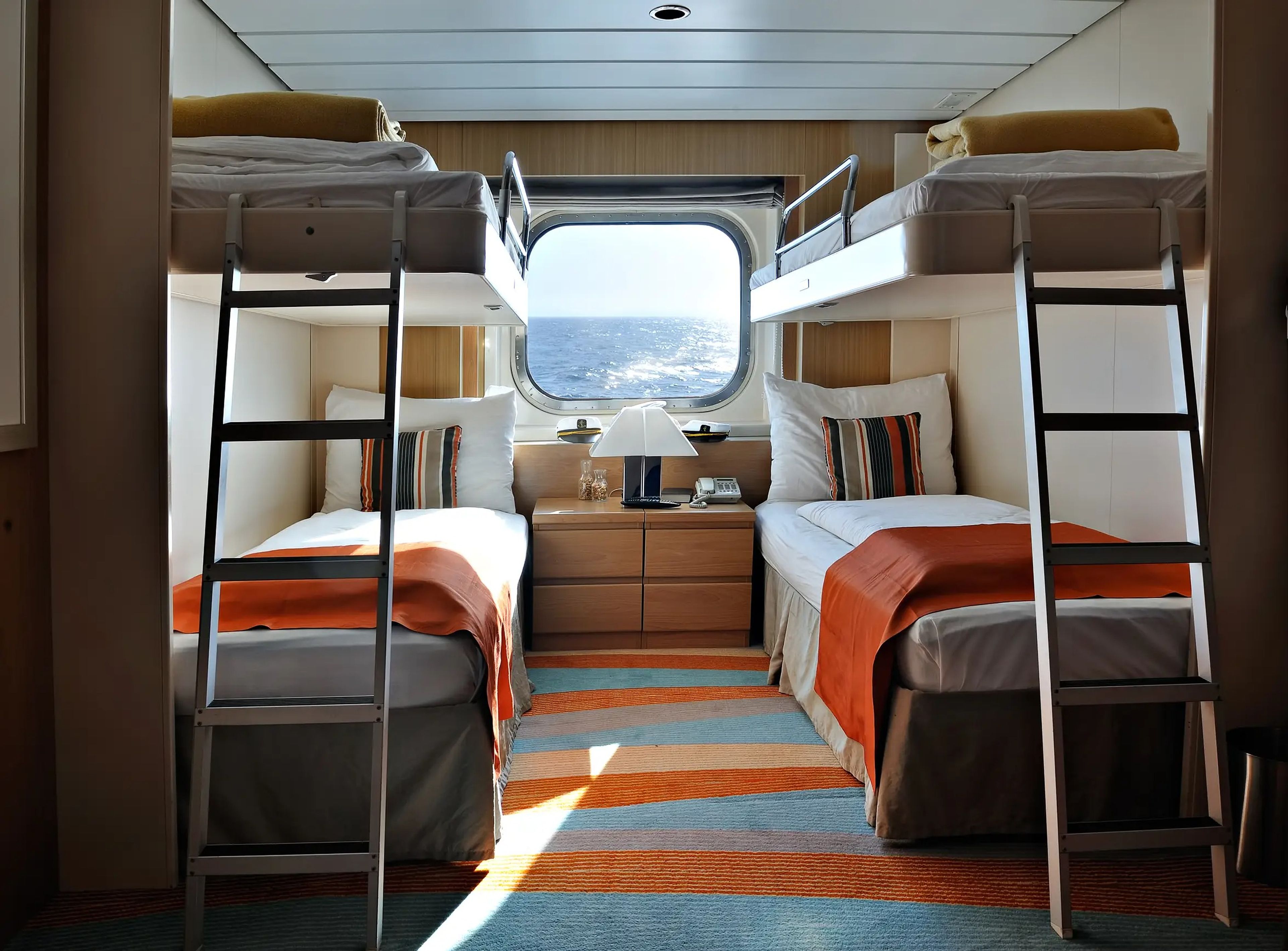 bunk beds in a cruise ship cabin with window