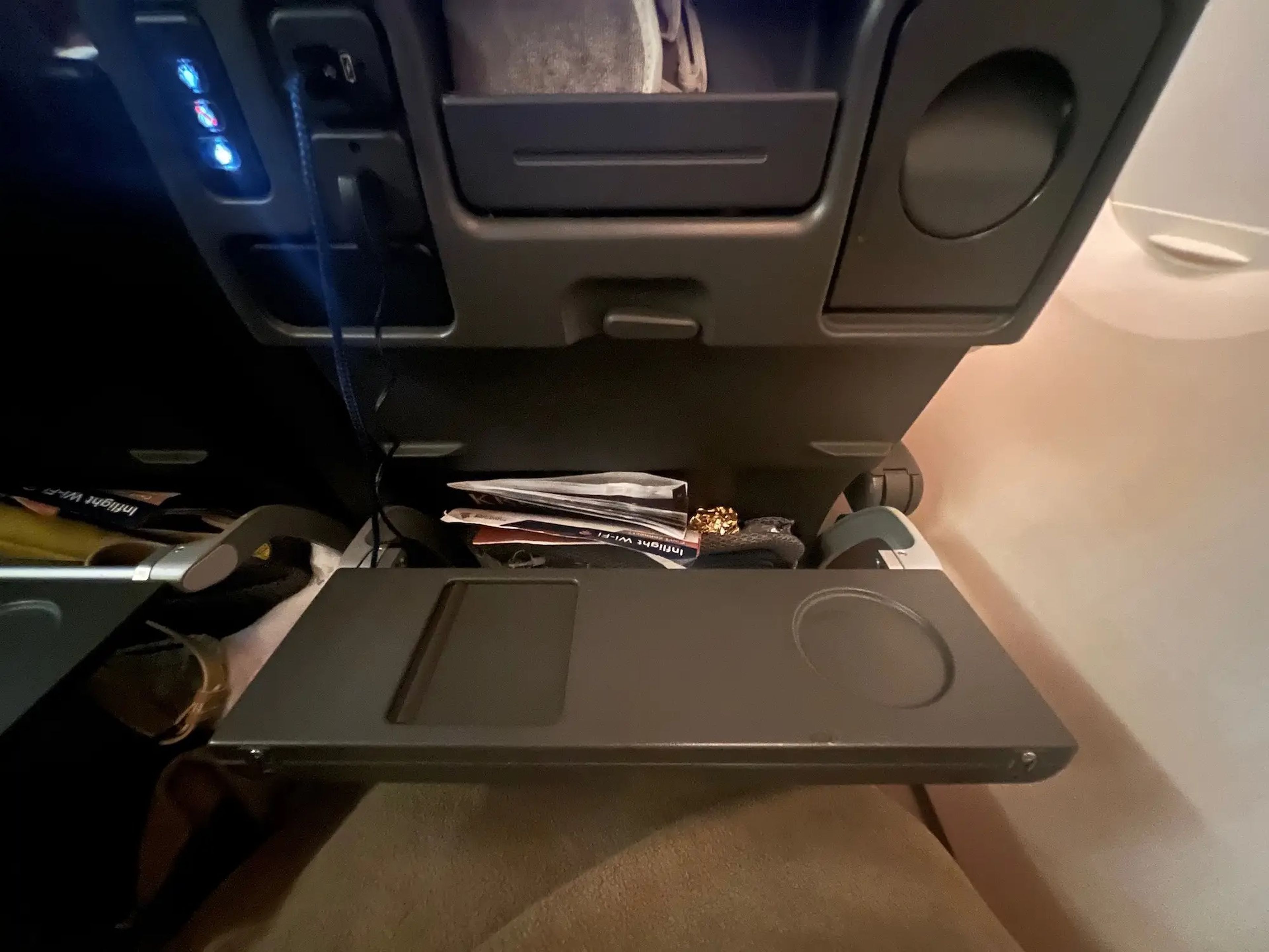 My tray table folded in half with the cupholder and mirror.