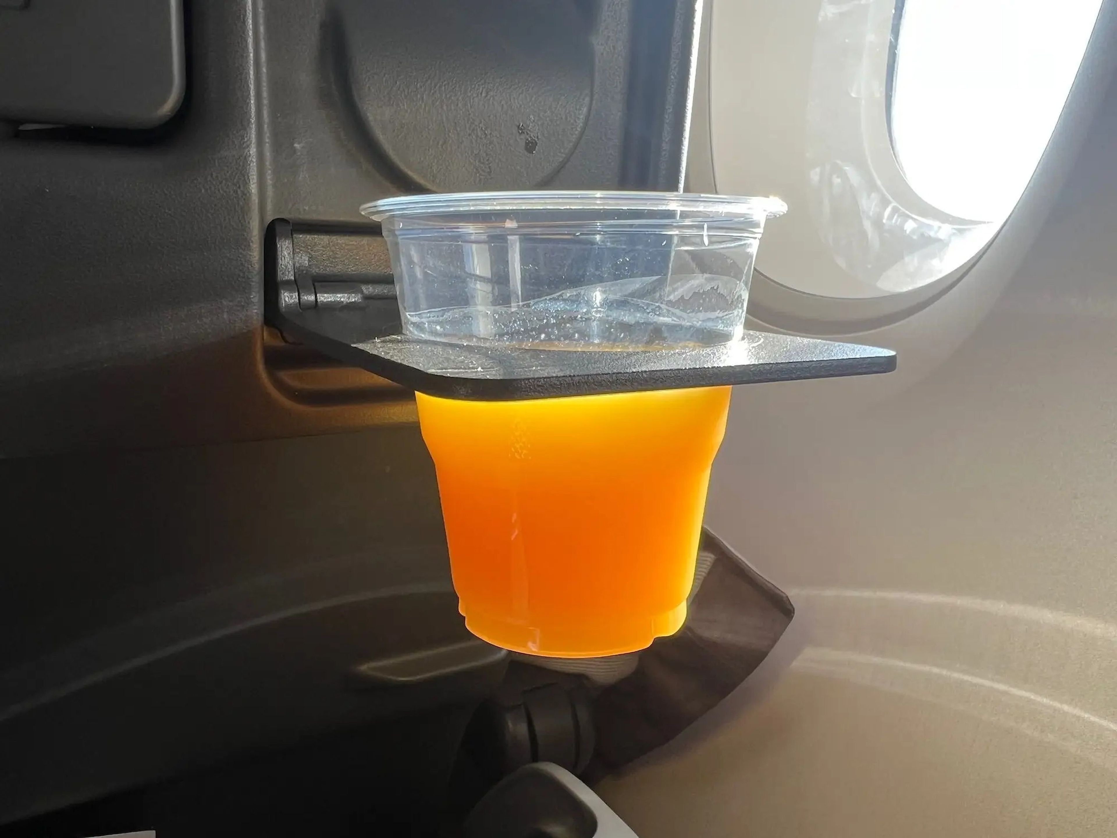 Orange juice in the cupholder.