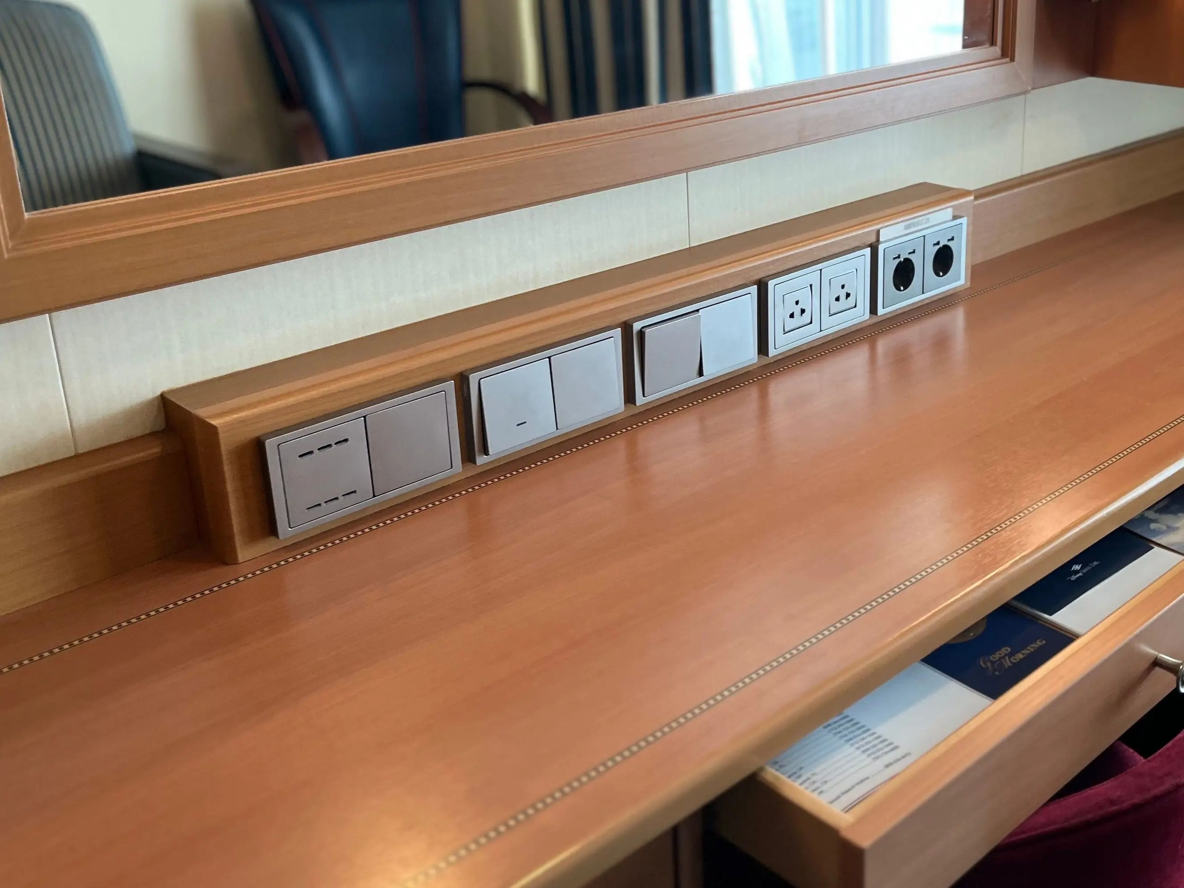 row of outlets on top of the desk in the family stateroom on a disney cruise
