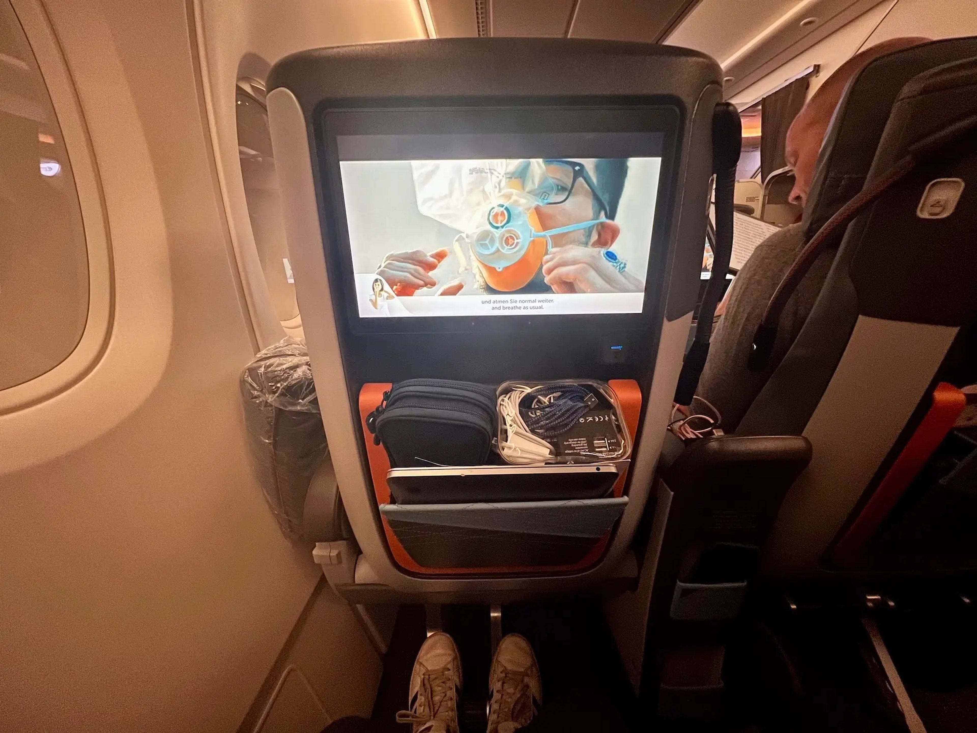 Singapore's pre-flight safety video with sign language in the bottom left corner.
