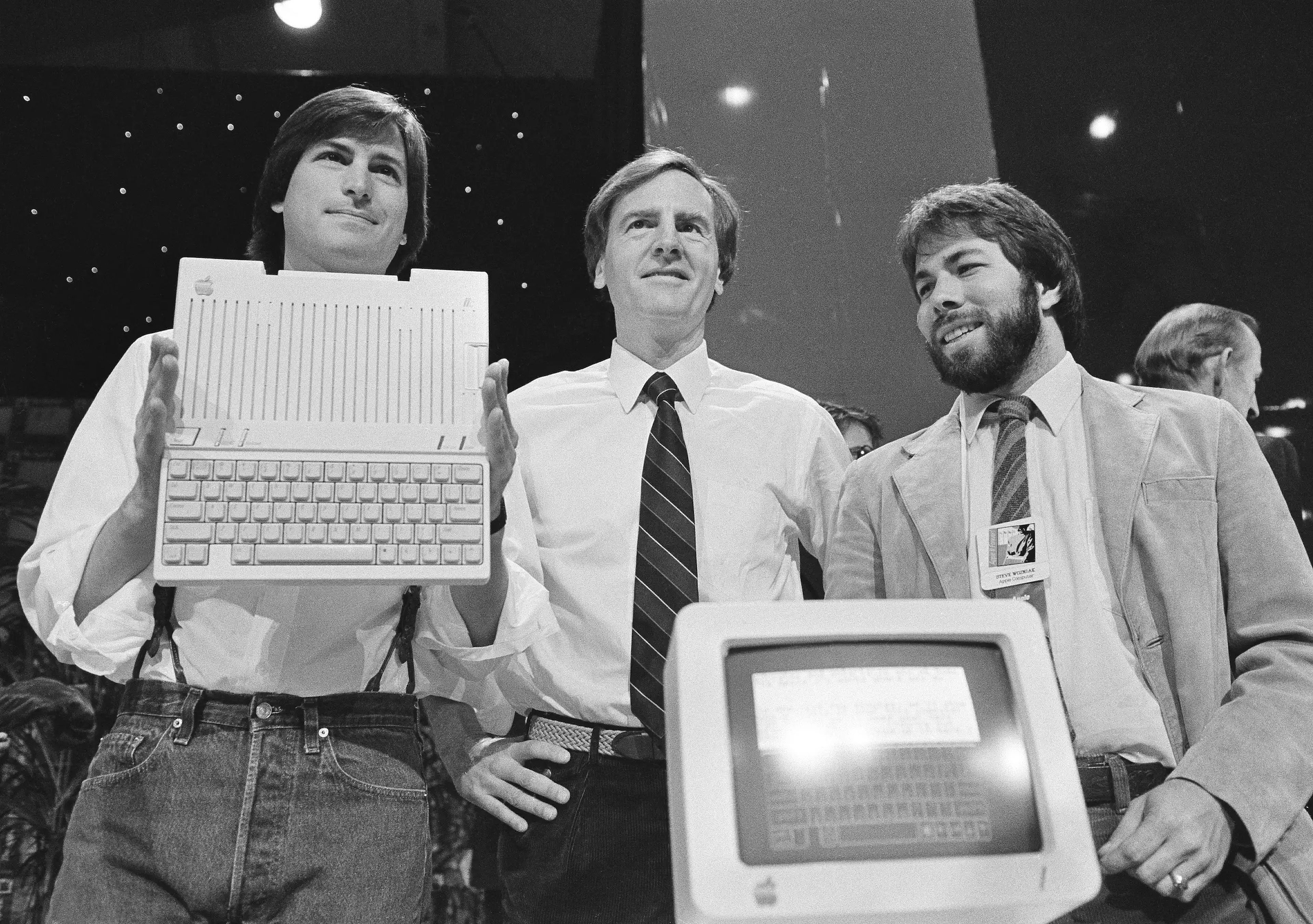 Steve Jobs (left), John Sculley (center), and Steve Wozniak unveil the new Apple II computer in San Francisco in 1984.