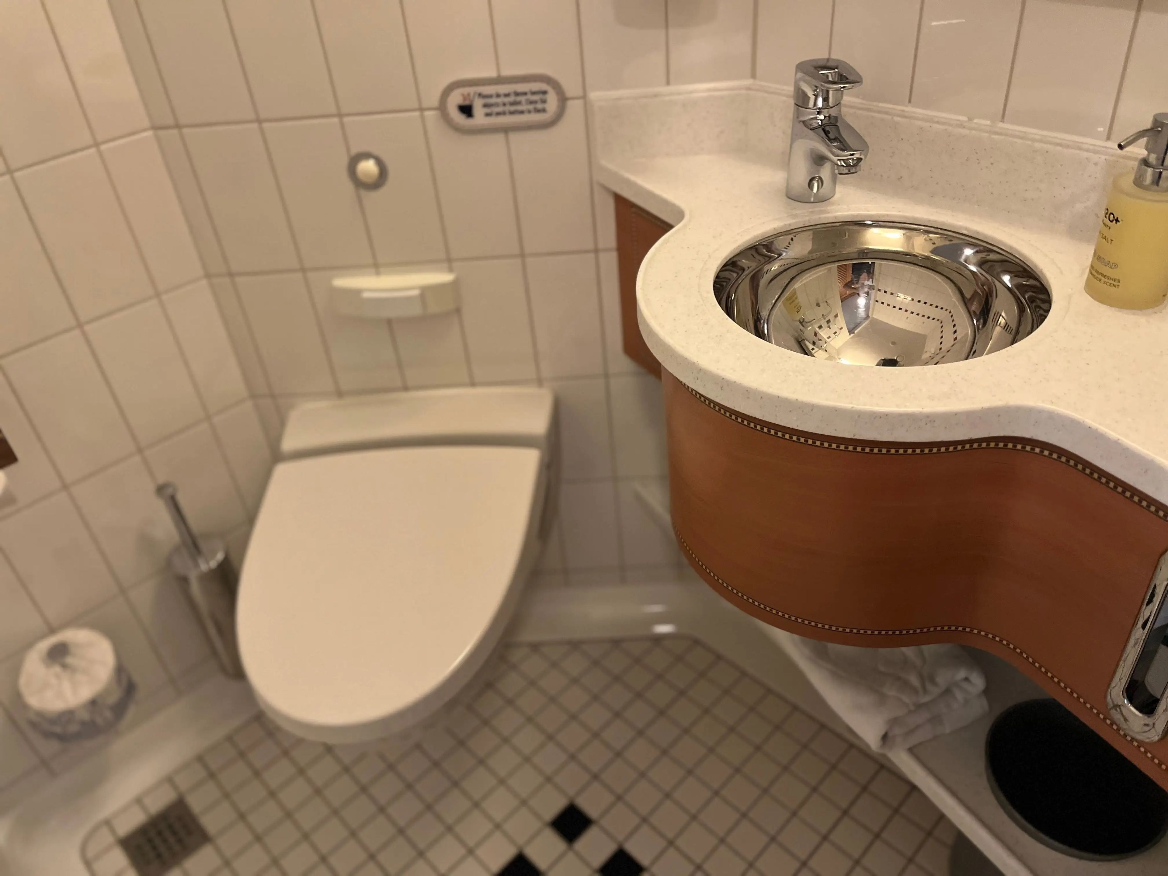 toilet with a sink in a split bathroom in a disney cruise room