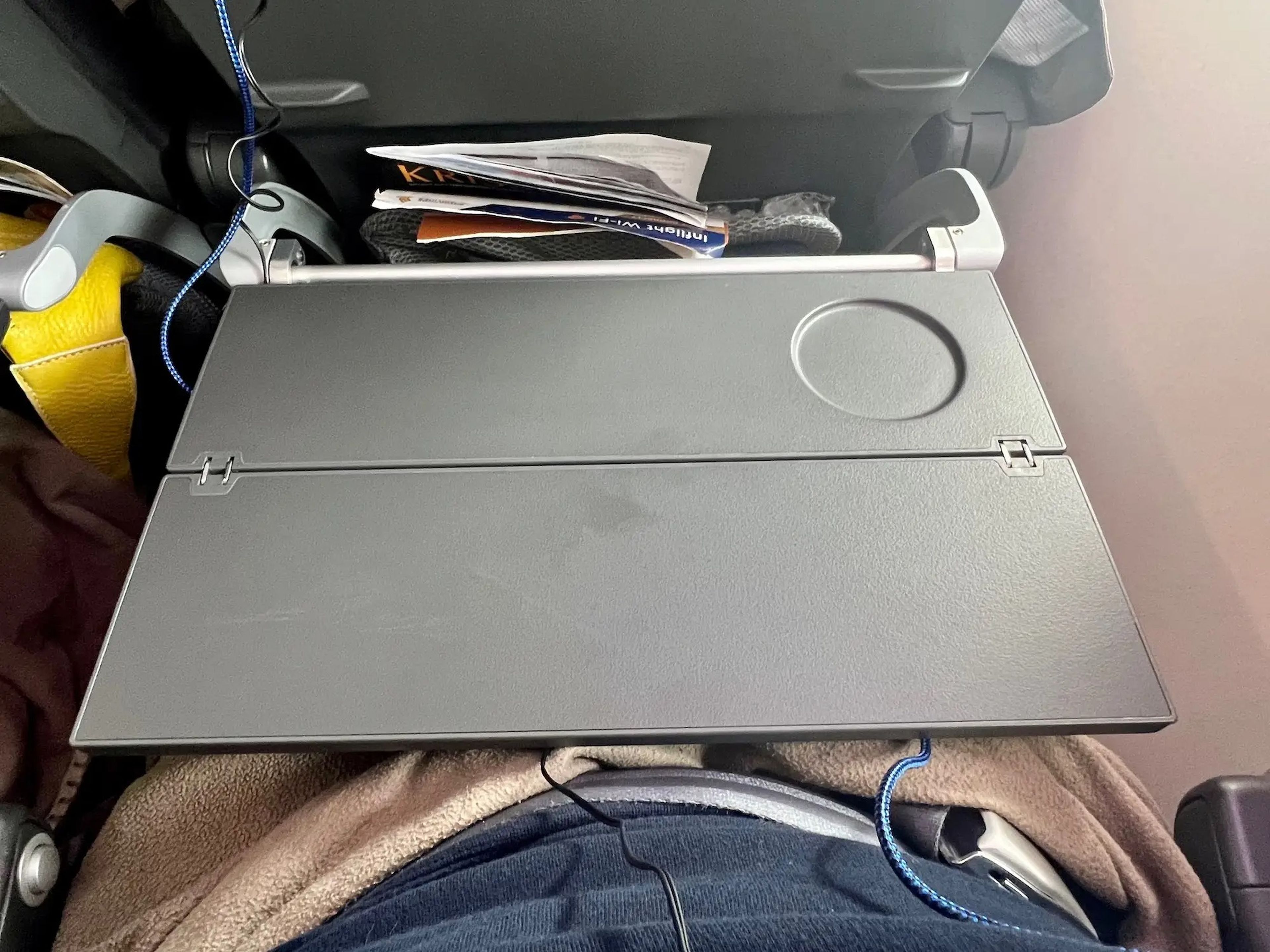 The tray table fully folded out.