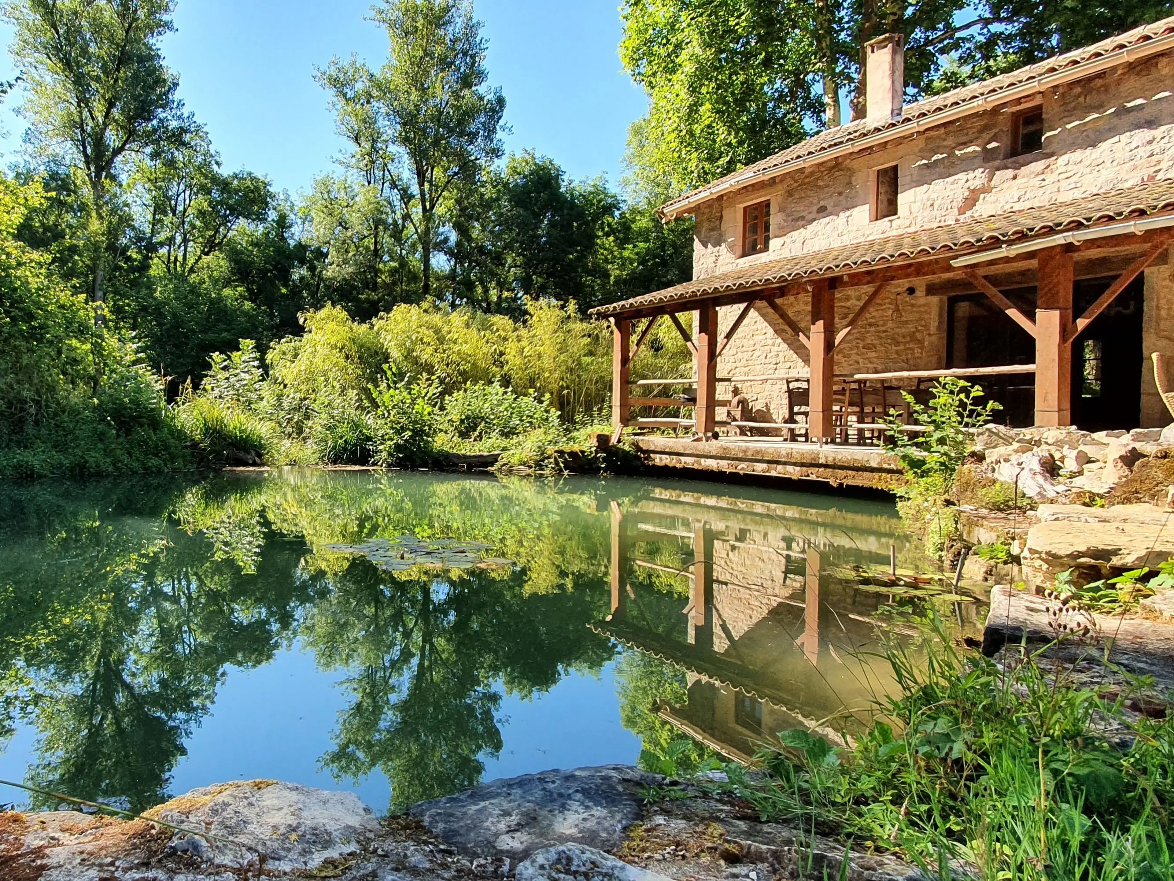 View of Airbnb 13th century mill and private pond in France