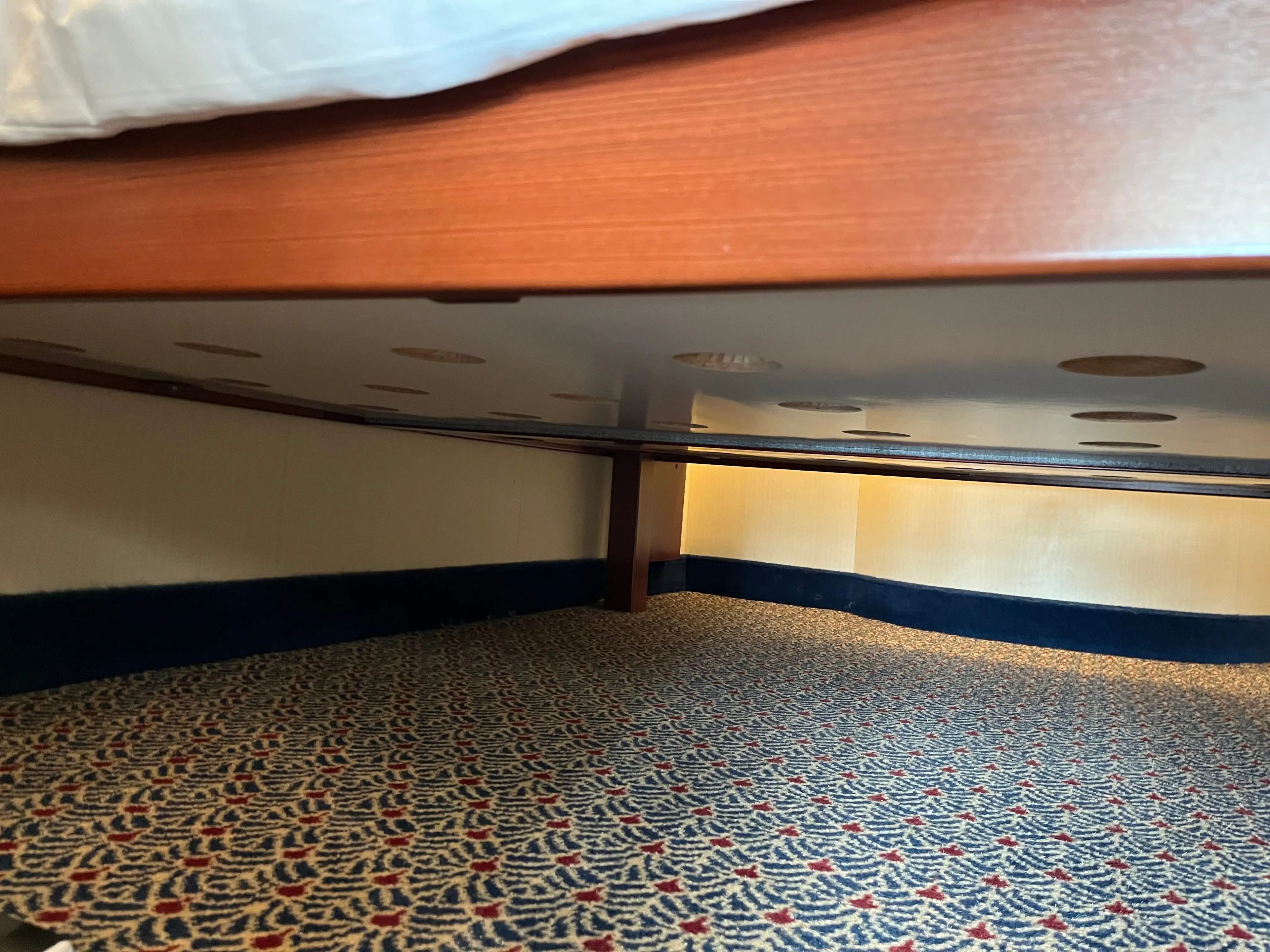 view under the queen-sized bed in a family stateroom on a disney cruise