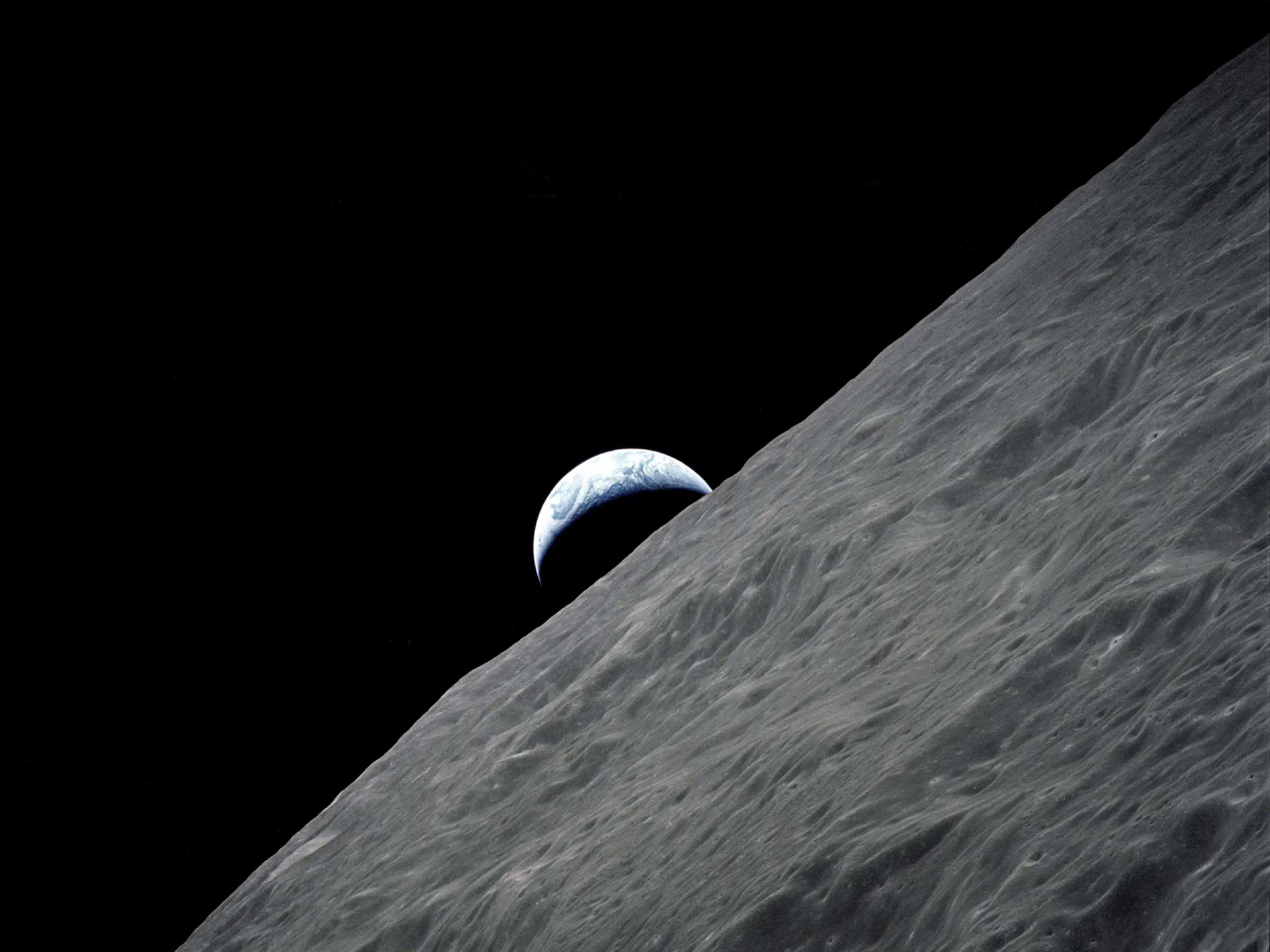 La Tierra en cuarto creciente se ve sobre el horizonte lunar en esta fotografía tomada desde la nave Apolo 17 (1972).