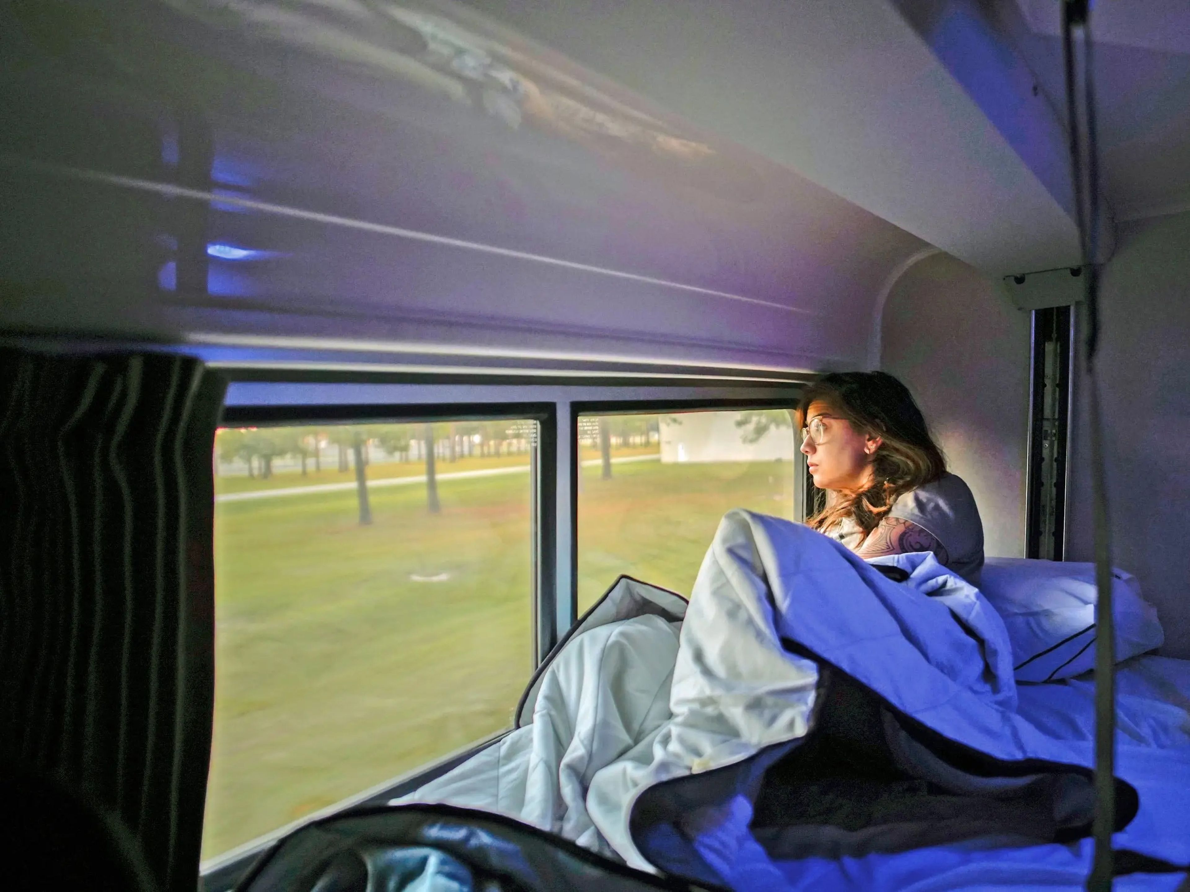 The author watches the sunrise from her bed during an overnight train ride from NYC to Miami in October 2021.