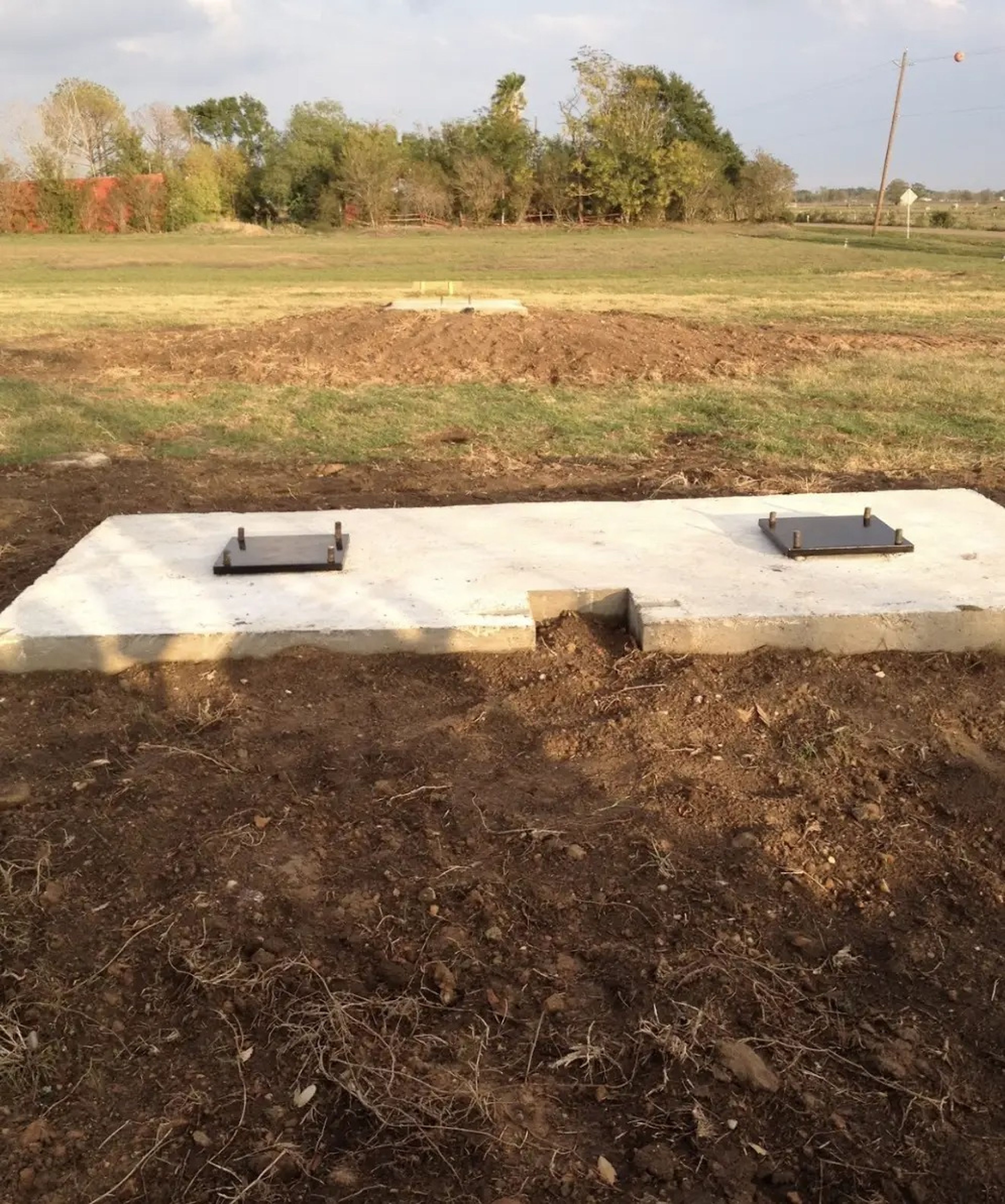 A concrete slab with two bases for an airplane to be set upon.