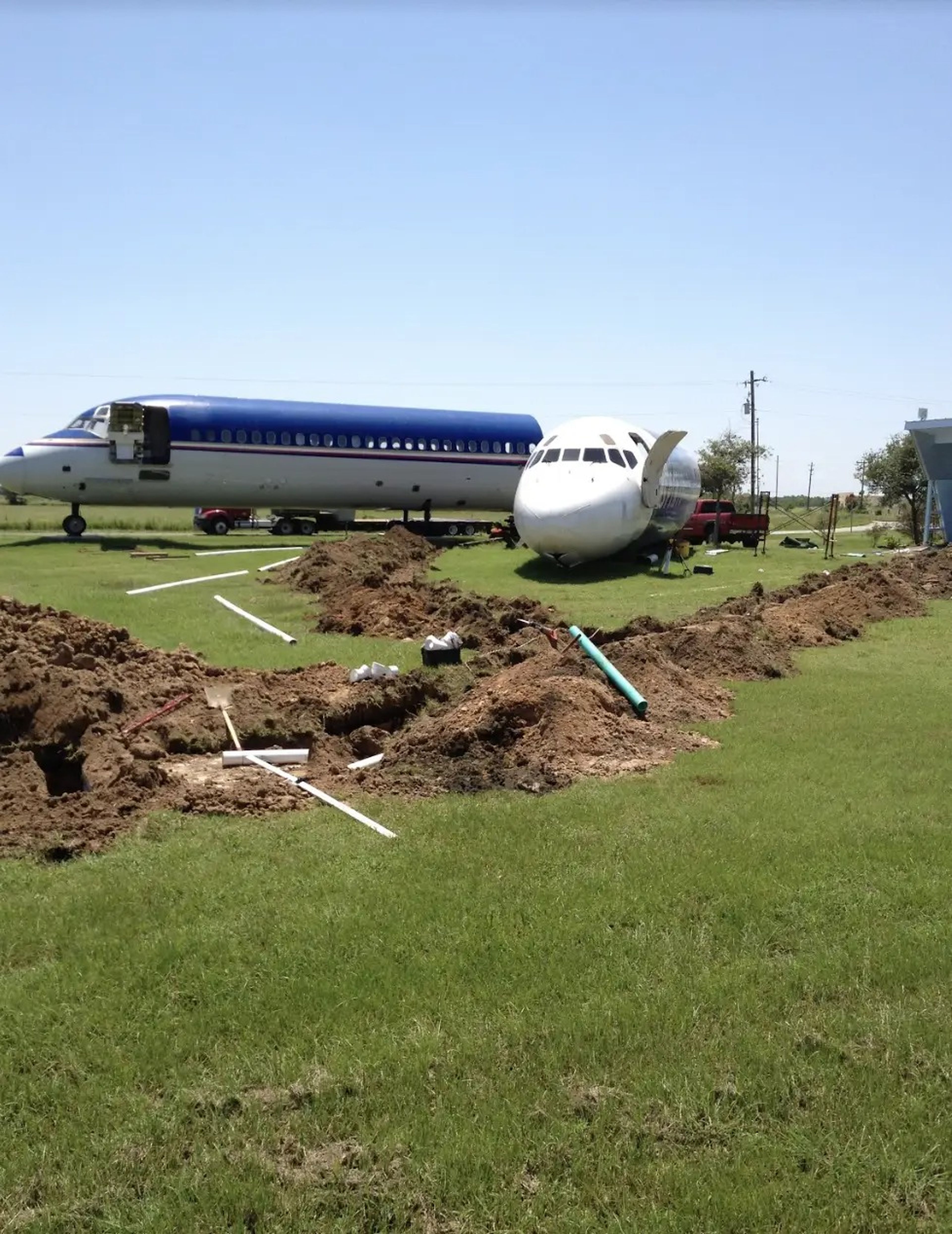 Digging trenches for pipes and wires for the DC-9 Spirit Airlines and MD-80 to have running water and electricity.