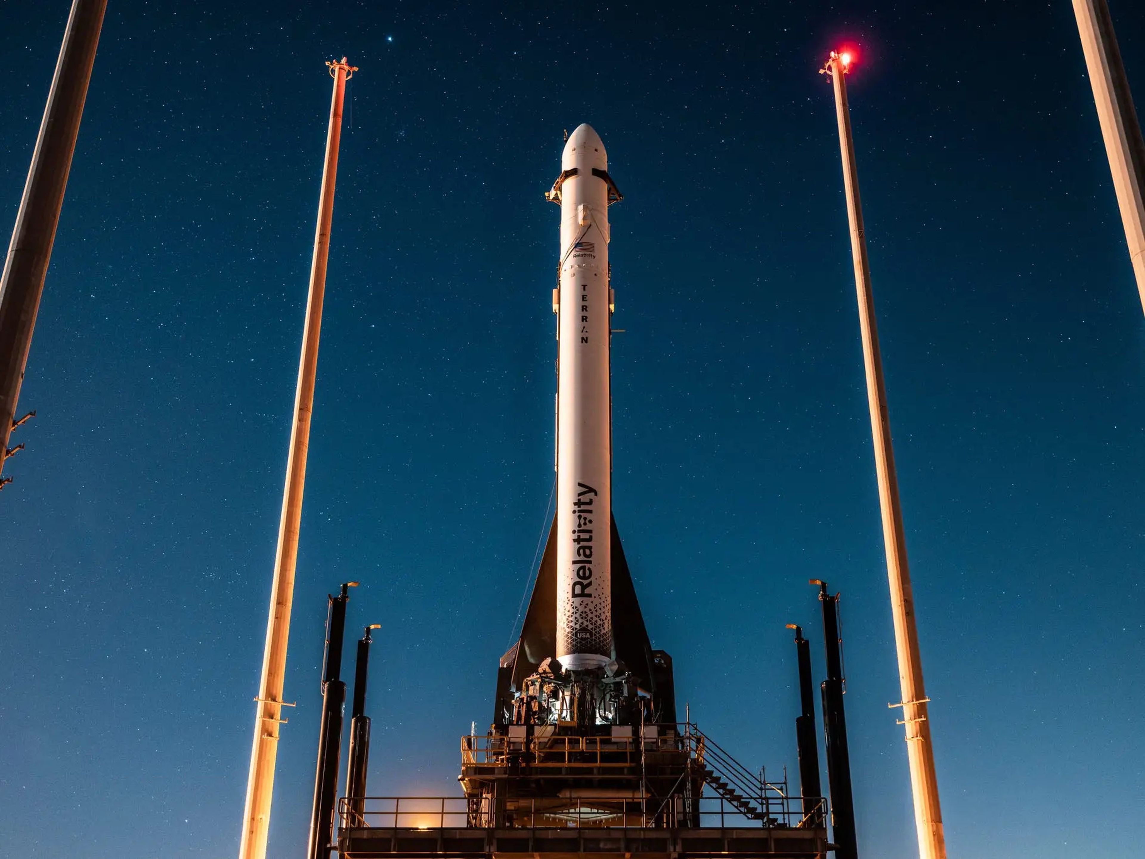 Terran 1 rocket is shown on the launchpad at night