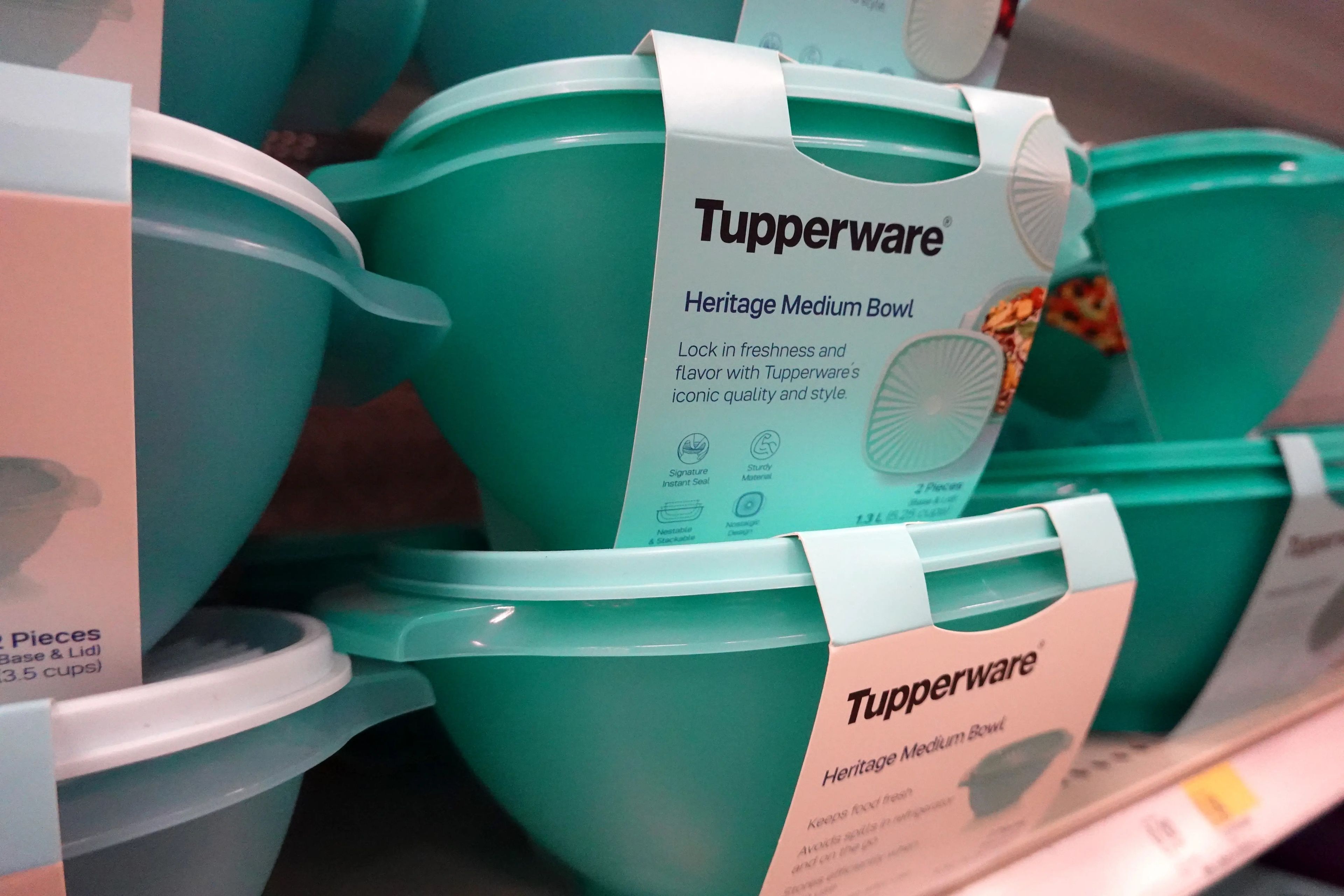 Turquoise Tupperware containers sit for sale on a shelf at a store in Chicago
