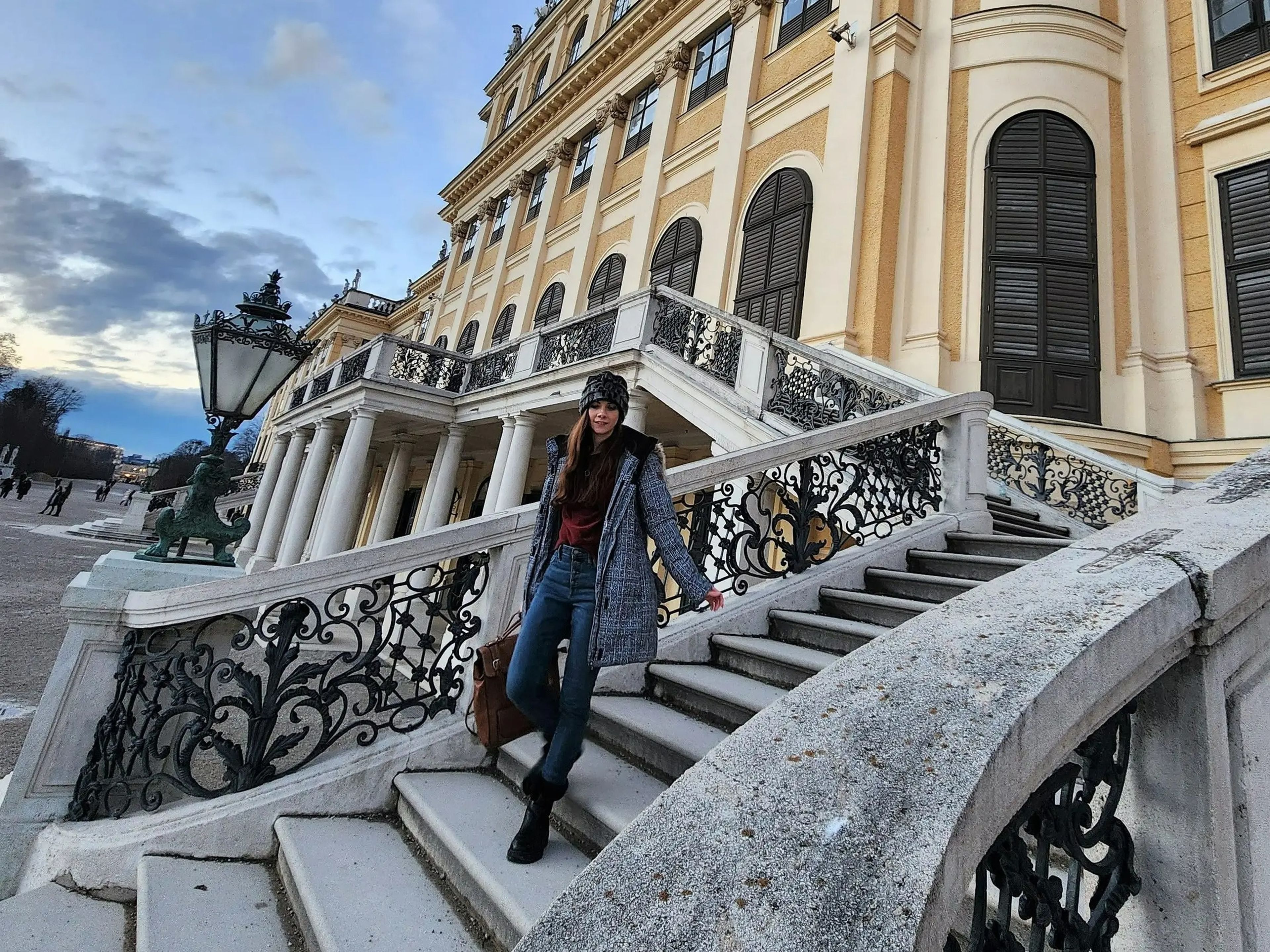 a woman standing on the steps of a building in Austria
