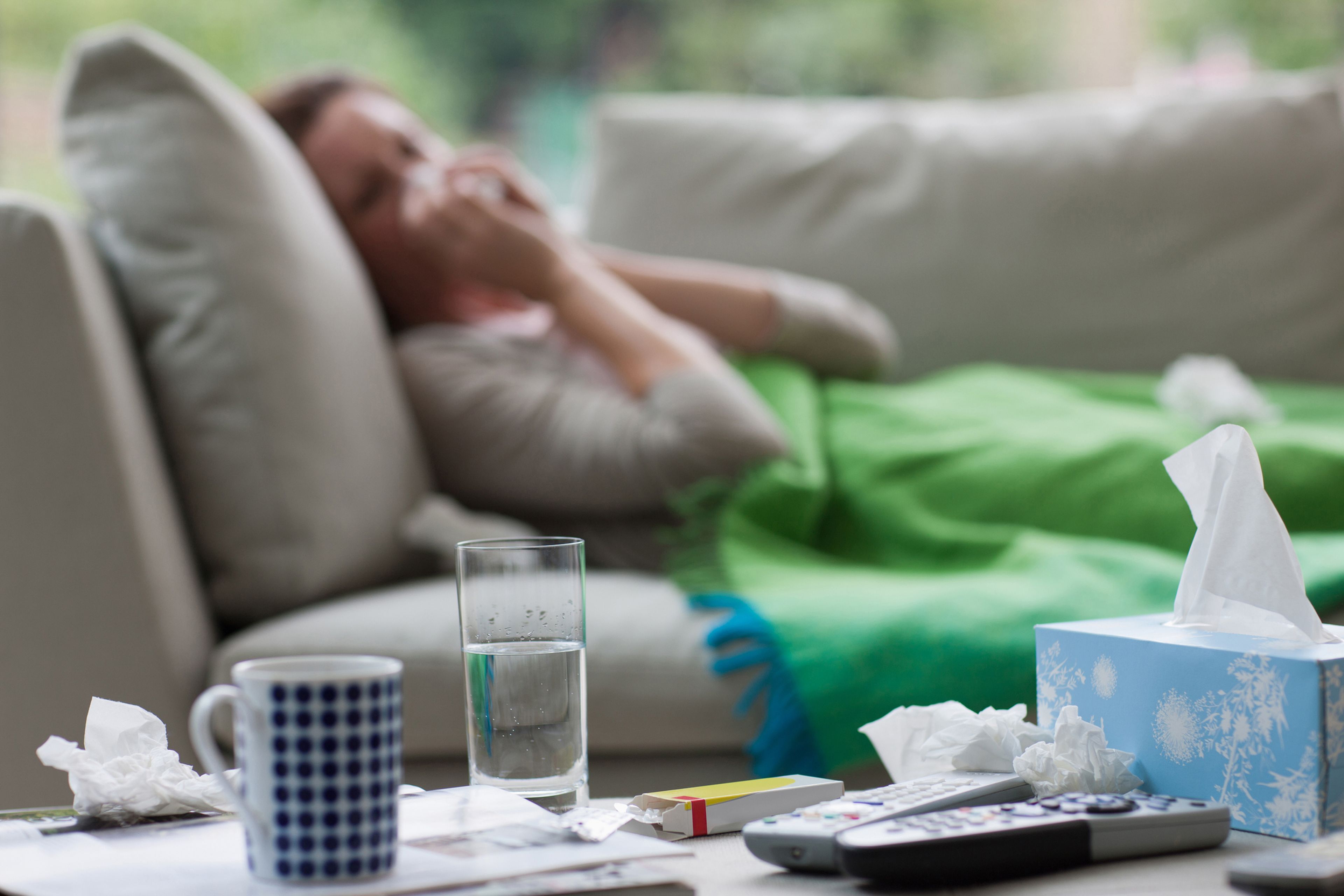 Mujer enferma con resfriado en el sofá