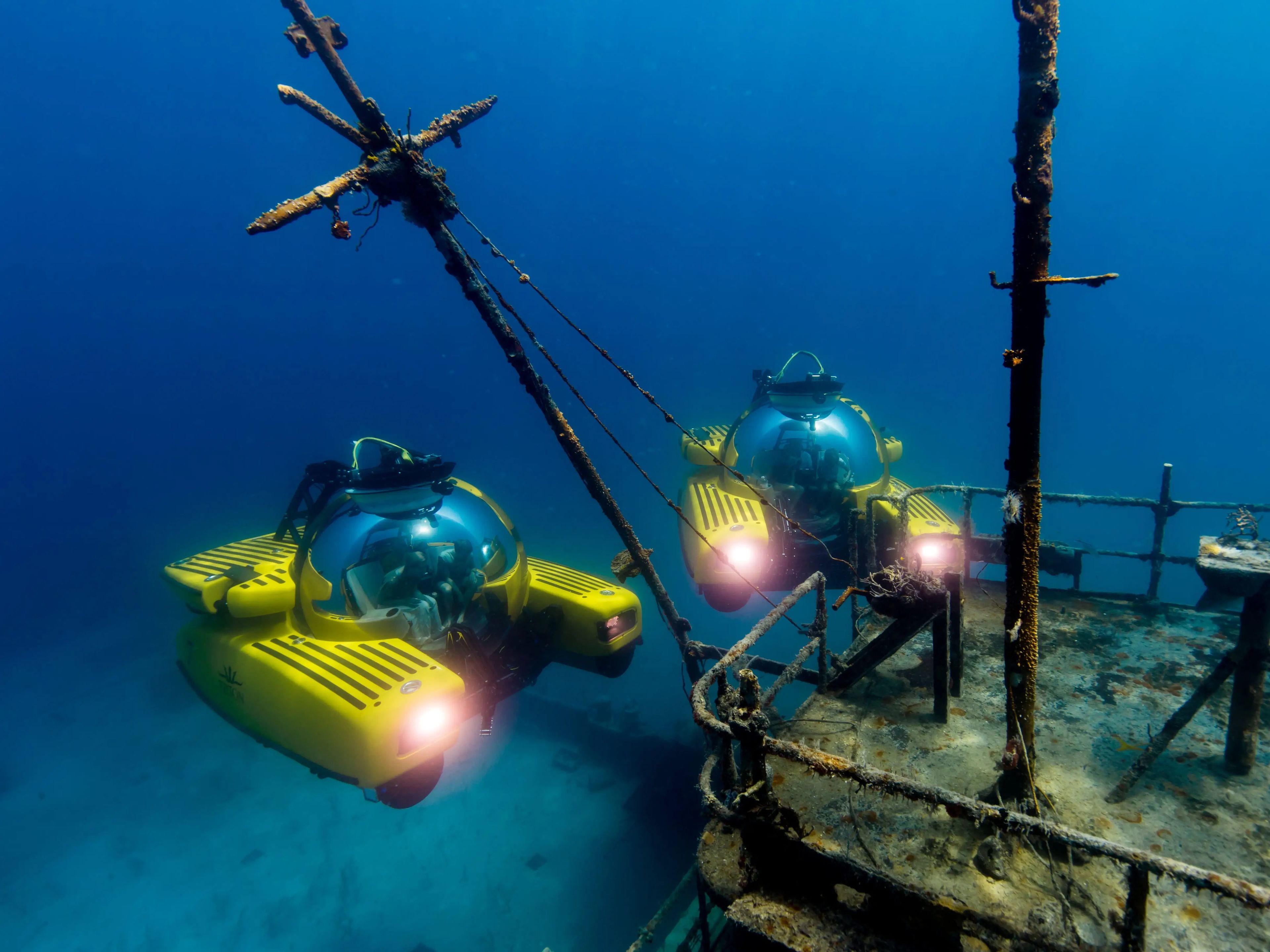 Two Triton Submersibles exploring a ship wreck.