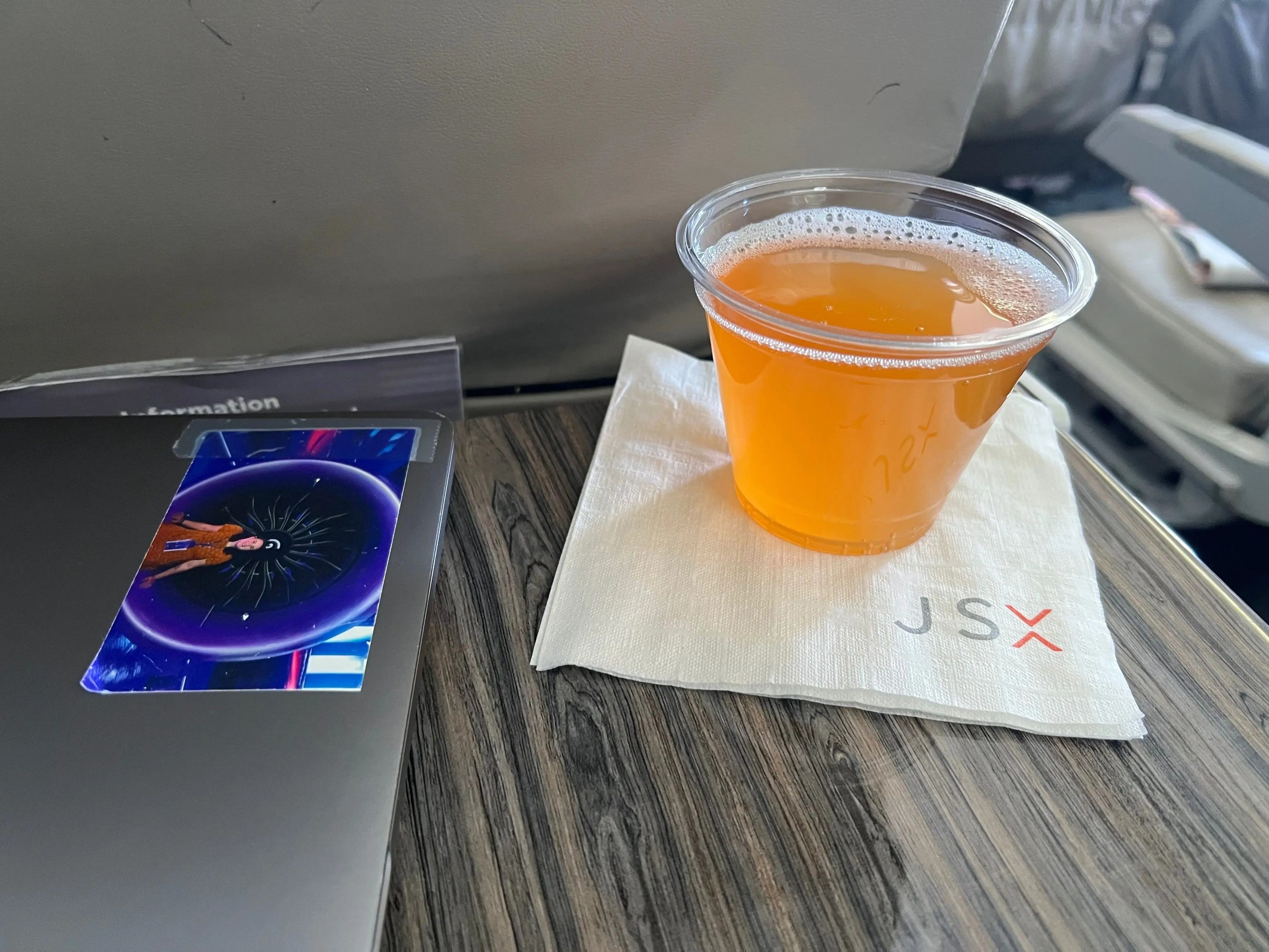 An orange Bellini on a tray table on JSX.