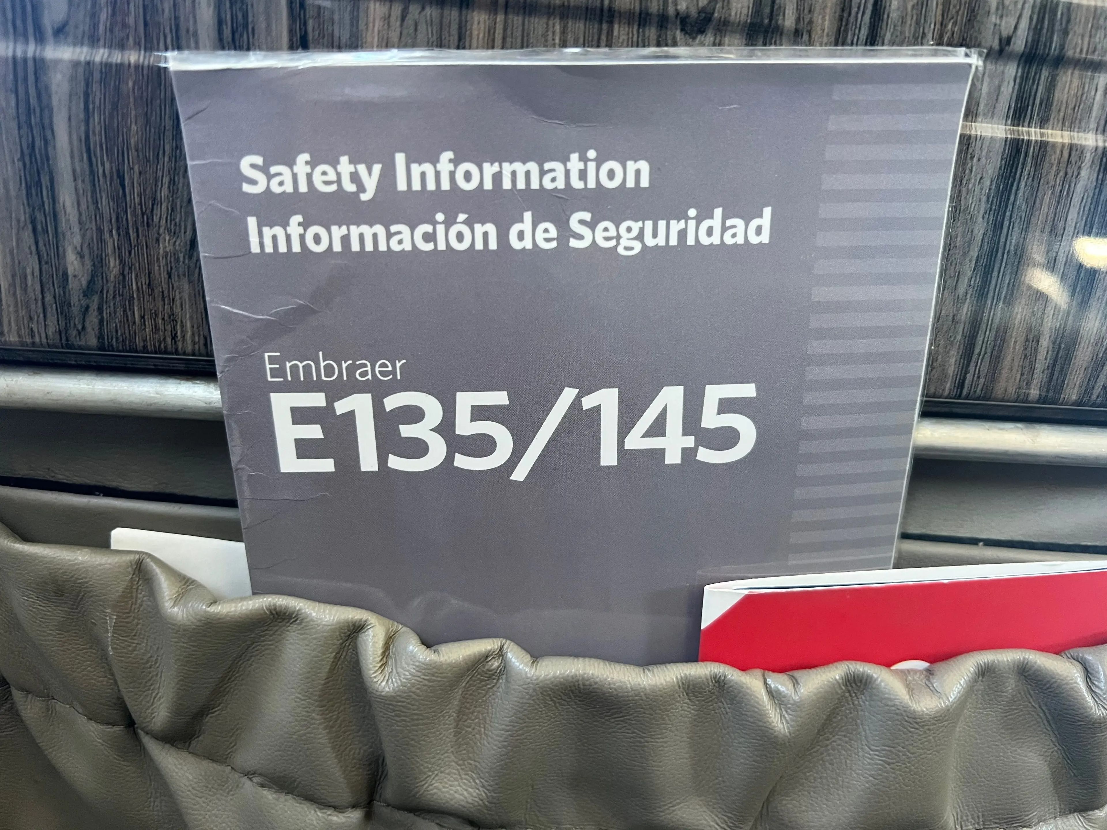 A safety information pamphlet onboard a JSX Embraer 135/145 aircraft.