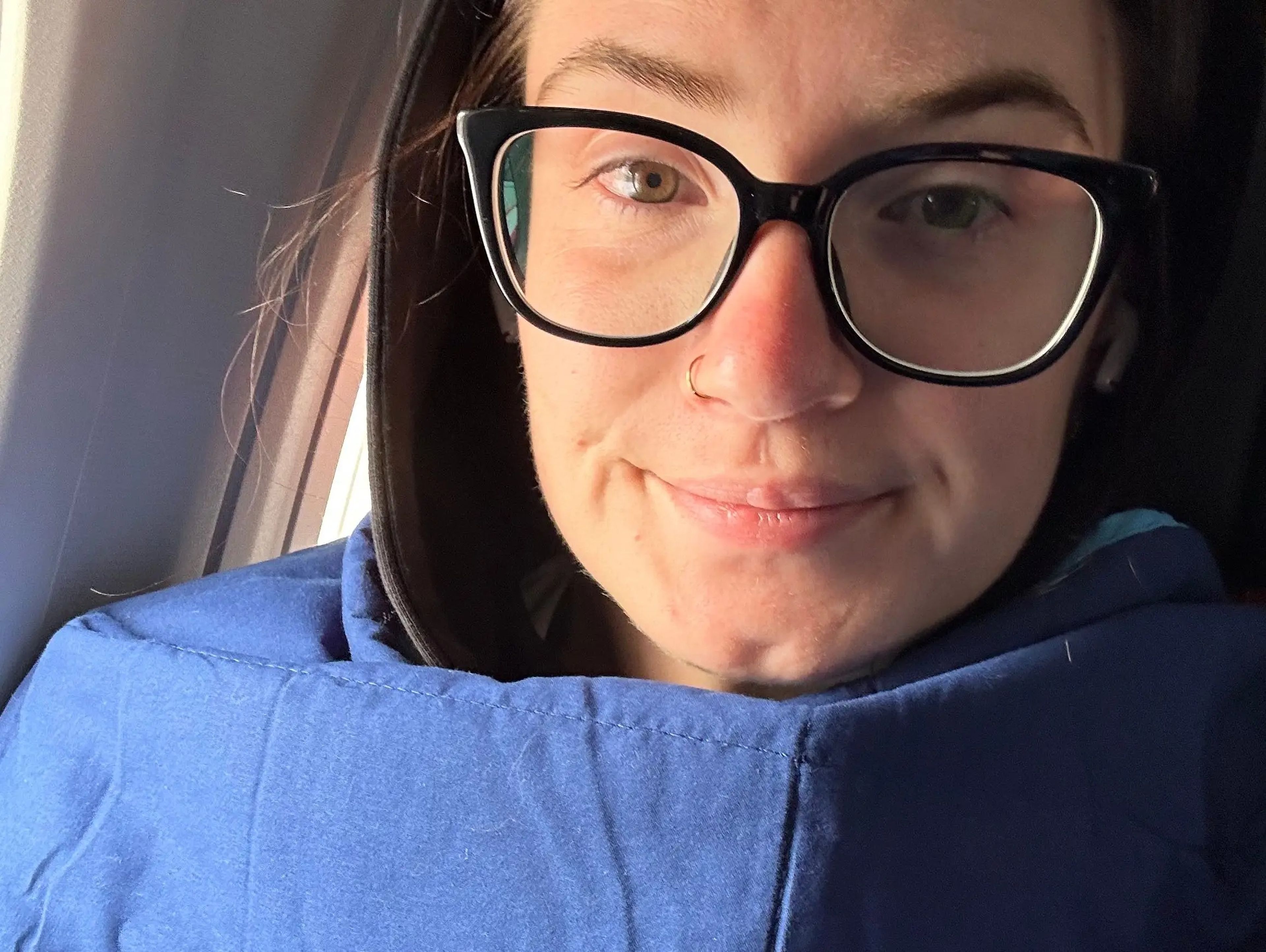 Insider's reporter bundled up in blankets to sleep in economy.