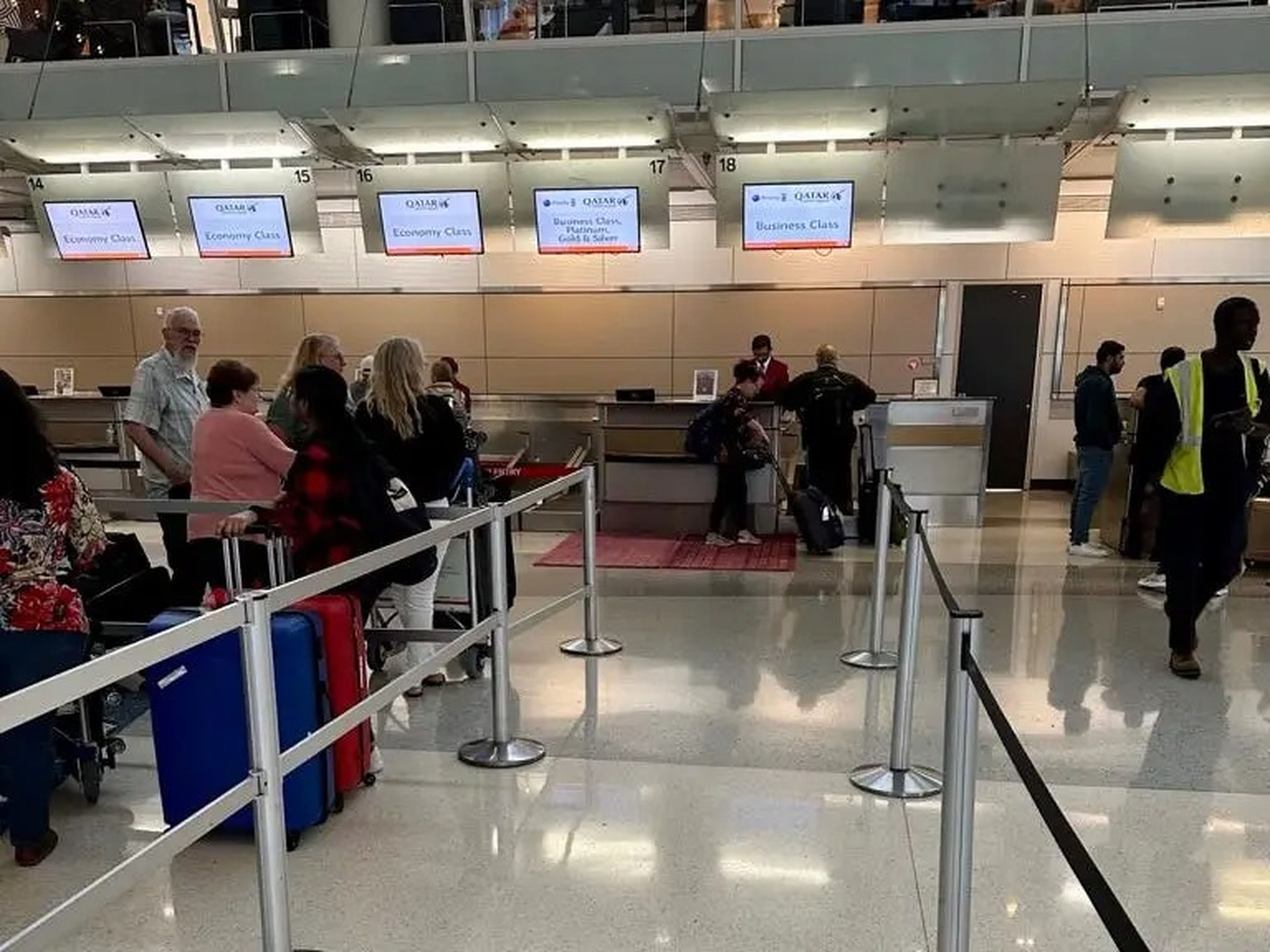 A line of people waiting to check in for Qatar Airways.