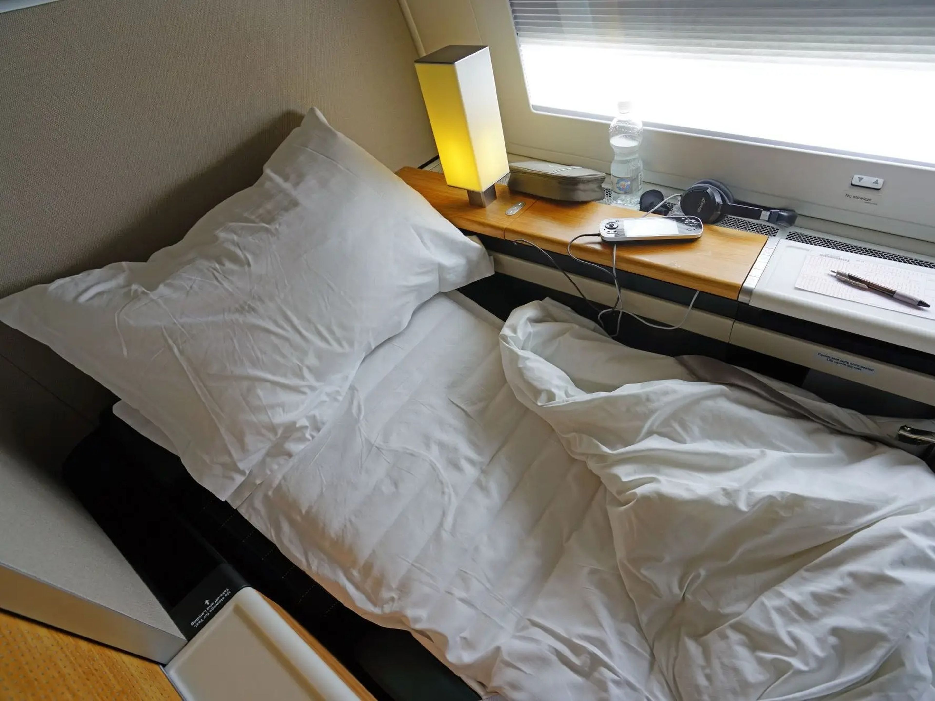 SWISS first class with lie-flat bed with bedding.