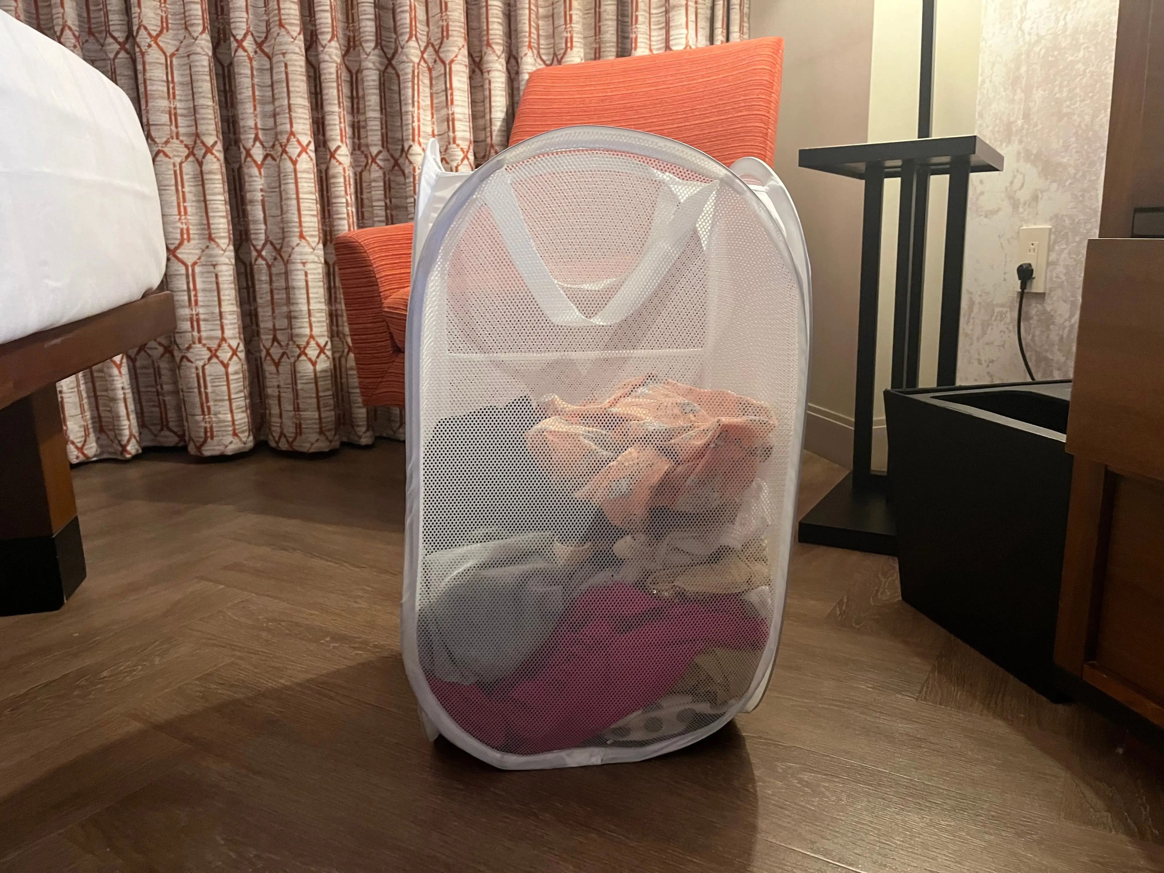 laundry basket filled with clothes in a hotel room