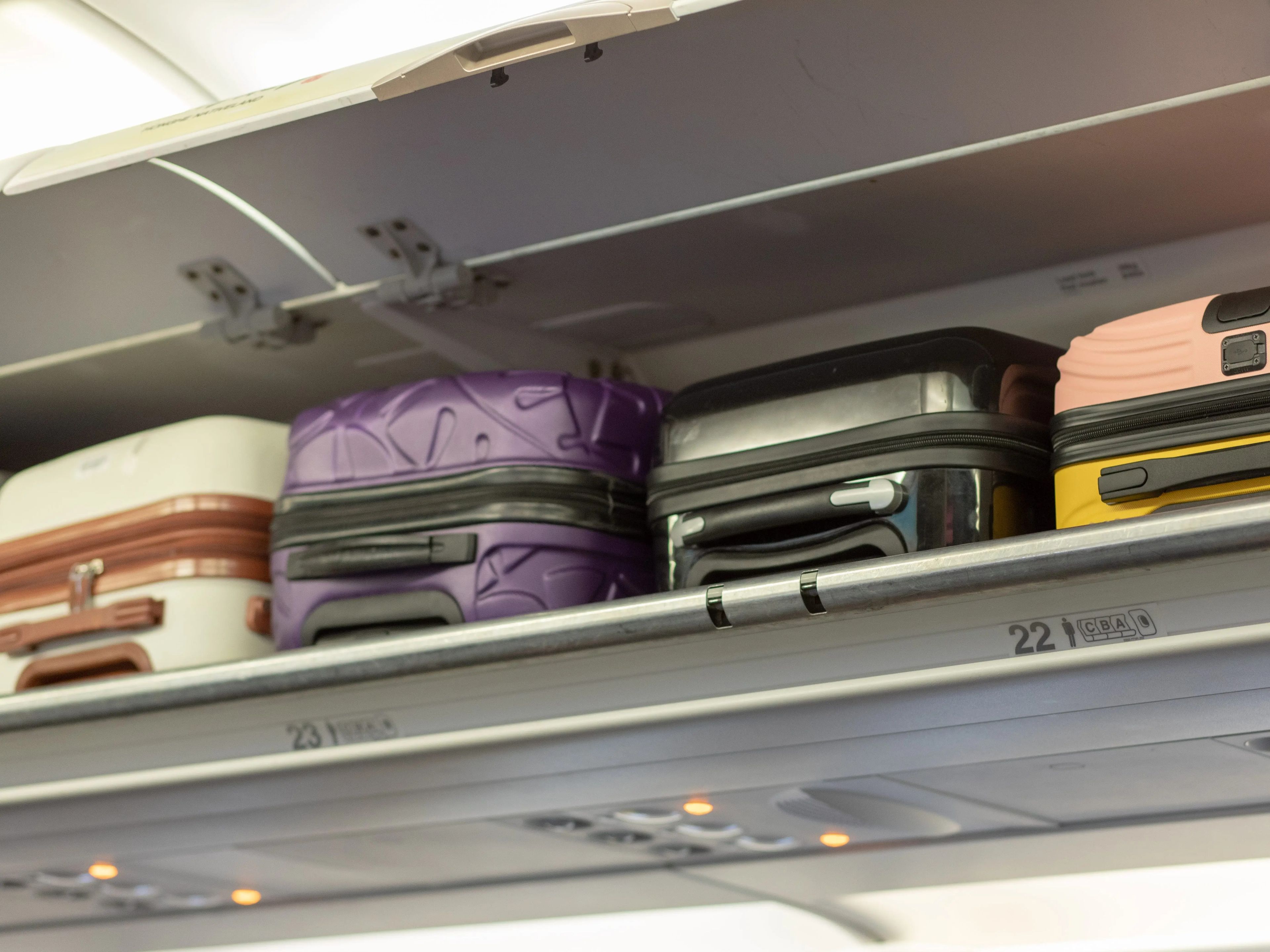 Luggage in the overhead bin on a plane.