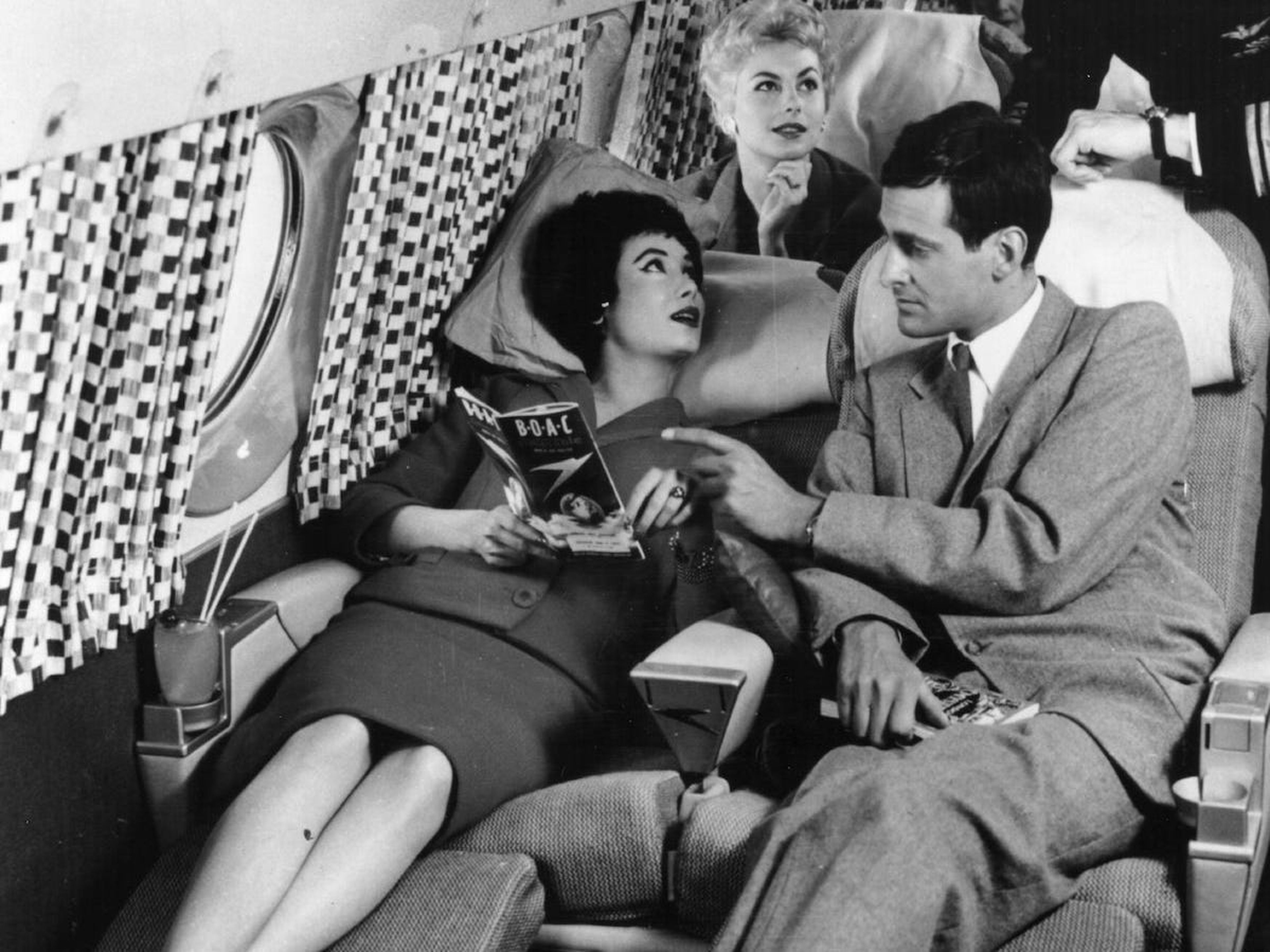 Pasajeros descansando en asientos reclinables en la década de 1950.