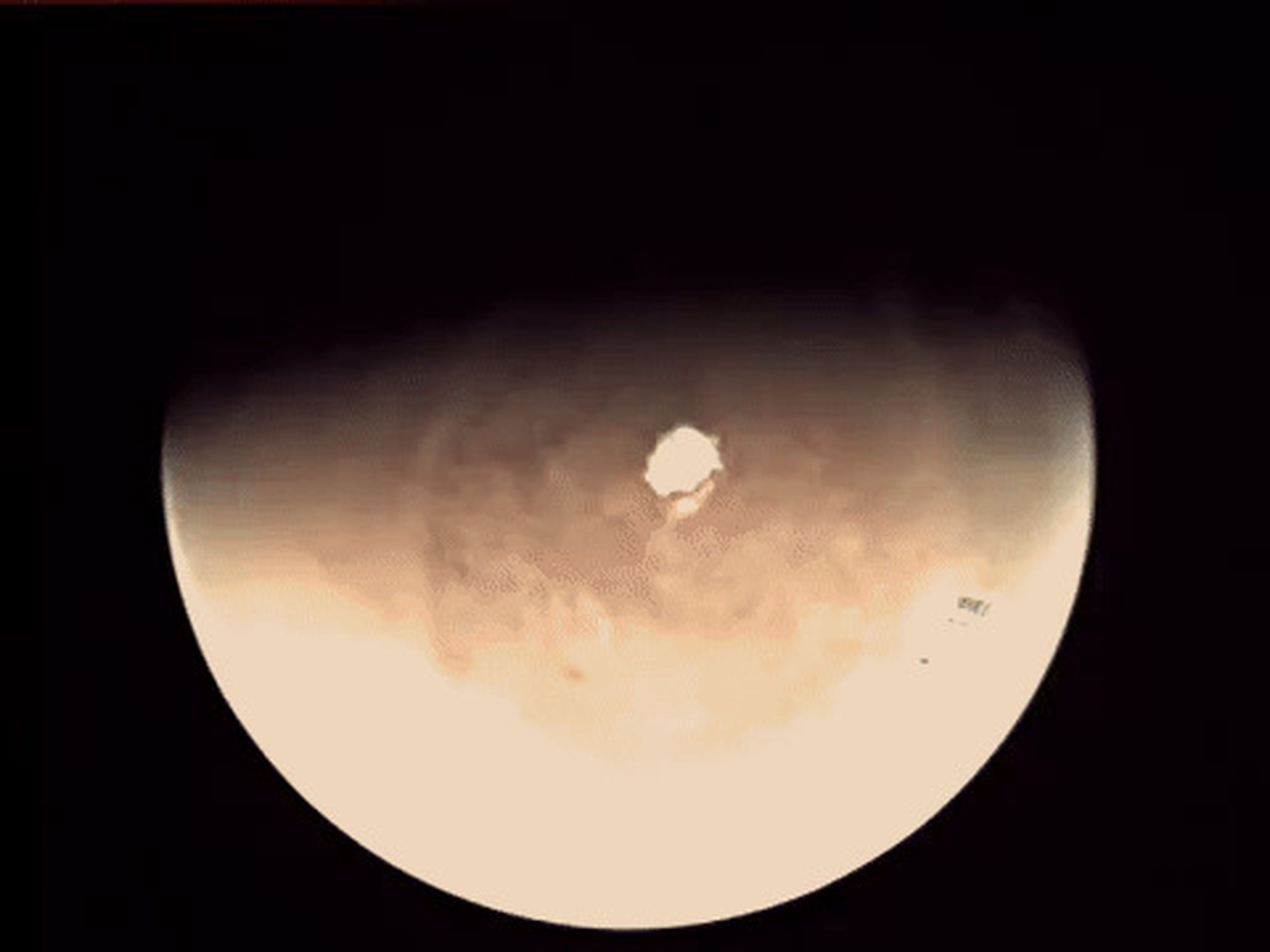 A composite of Mars Express images shows the satellite approaching Mars. Half of the planet is shaded